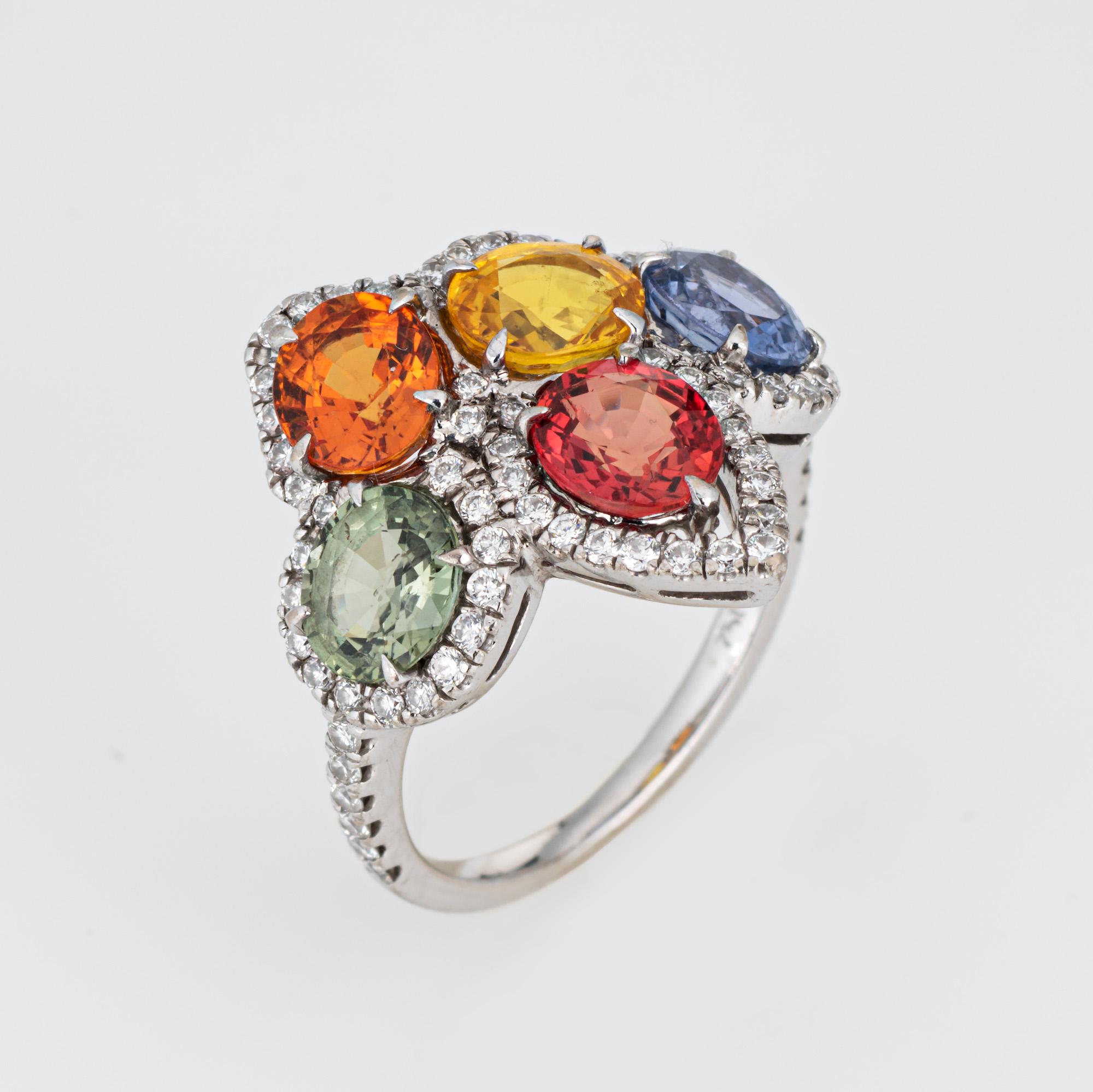 Finely detailed estate rainbow sapphire & diamond ring crafted in 18 karat white gold. 

Green, yellow, red, blue, and orange sapphires range in size from 5mm to 6mm. 70 full cut diamonds total an estimated 0.35 carats (estimated at H-I color and