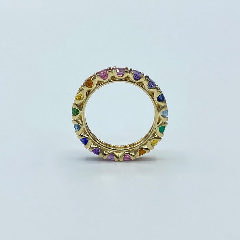 Rainbow Sapphire Emerald Semiprecious Stone 18 Karat Yellow Gold Ring Made in Italy
This multicolor eternity ring is set from 17 stones. It has yellow, orange, violet and blue sapphire; emerald, tourmaline, iolite, aquamarine, amethyst and