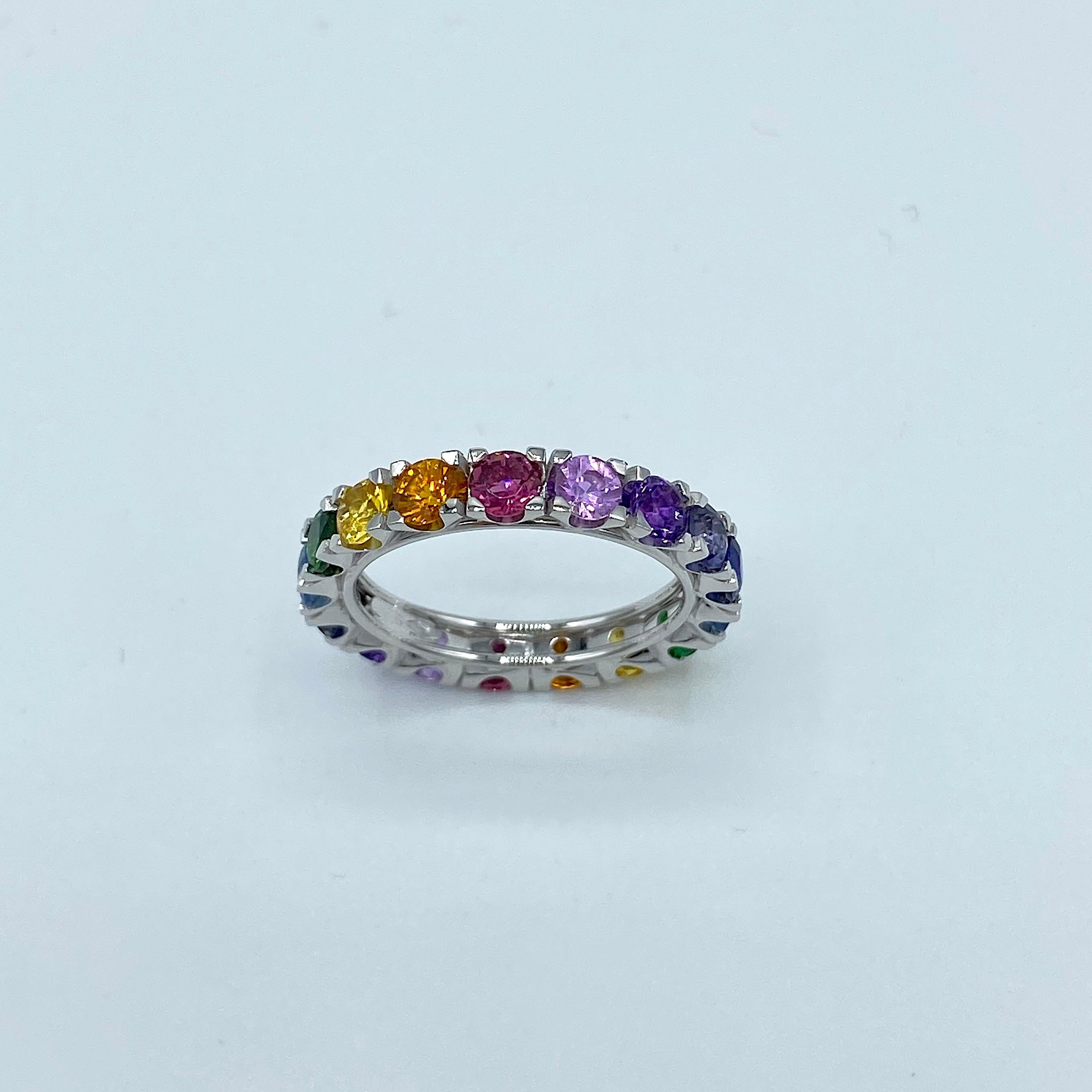  Rainbow Sapphire Semiprecious Stone 18 Karat White Gold Ring Made in Italy
This multicolor eternity ring is set from 17 stones. It has yellow, orange, violet and blue sapphire; tourmaline, iolite, aquamarine, amethyst and tzavorite. 
I put the