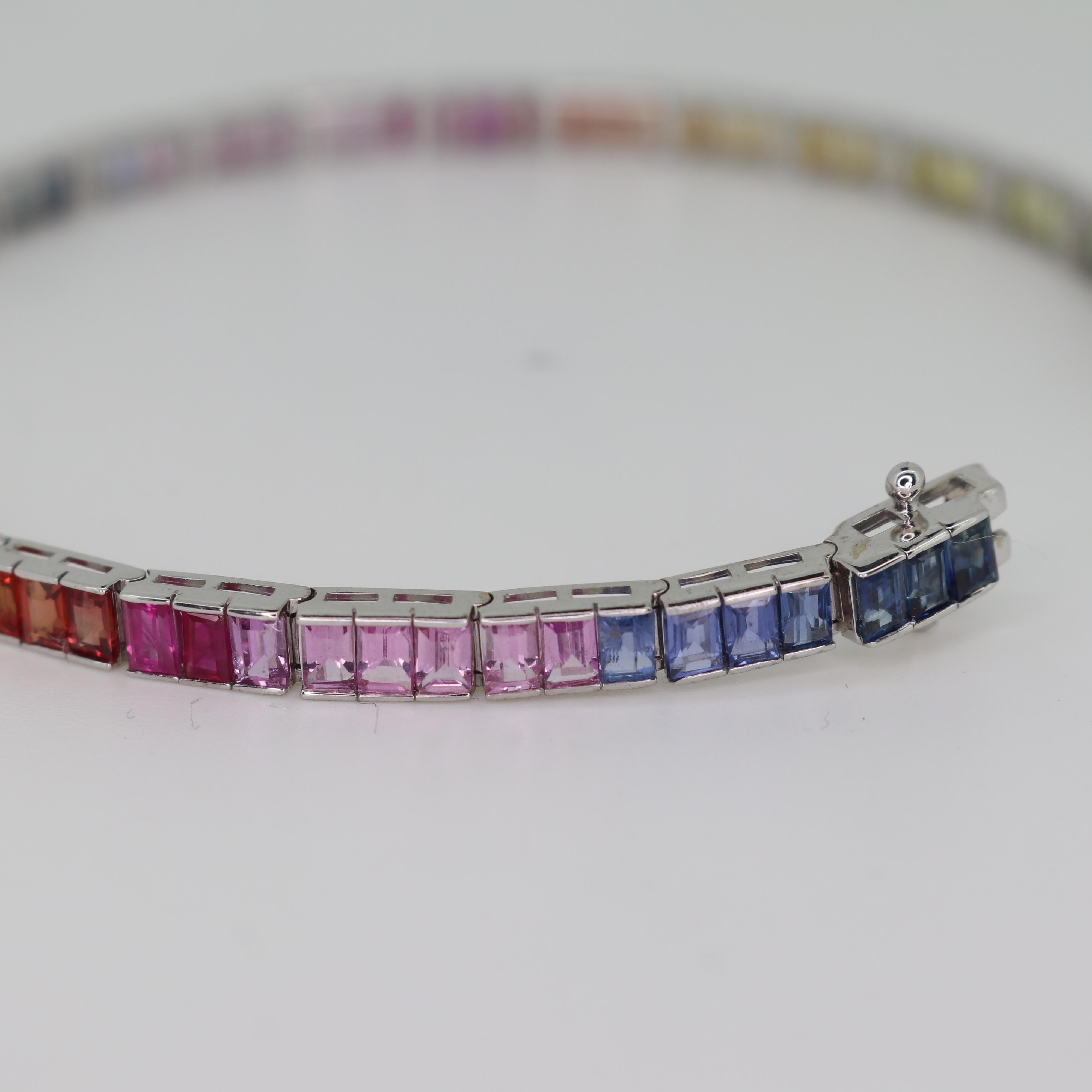 Indulge in the captivating allure of our Rainbow Sapphire Tennis Bracelet, a radiant marvel meticulously crafted in 18K white gold. Each natural sapphire, cut into elegant 4x2mm baguettes, forms a stunning rainbow spectrum of colors that dazzles the