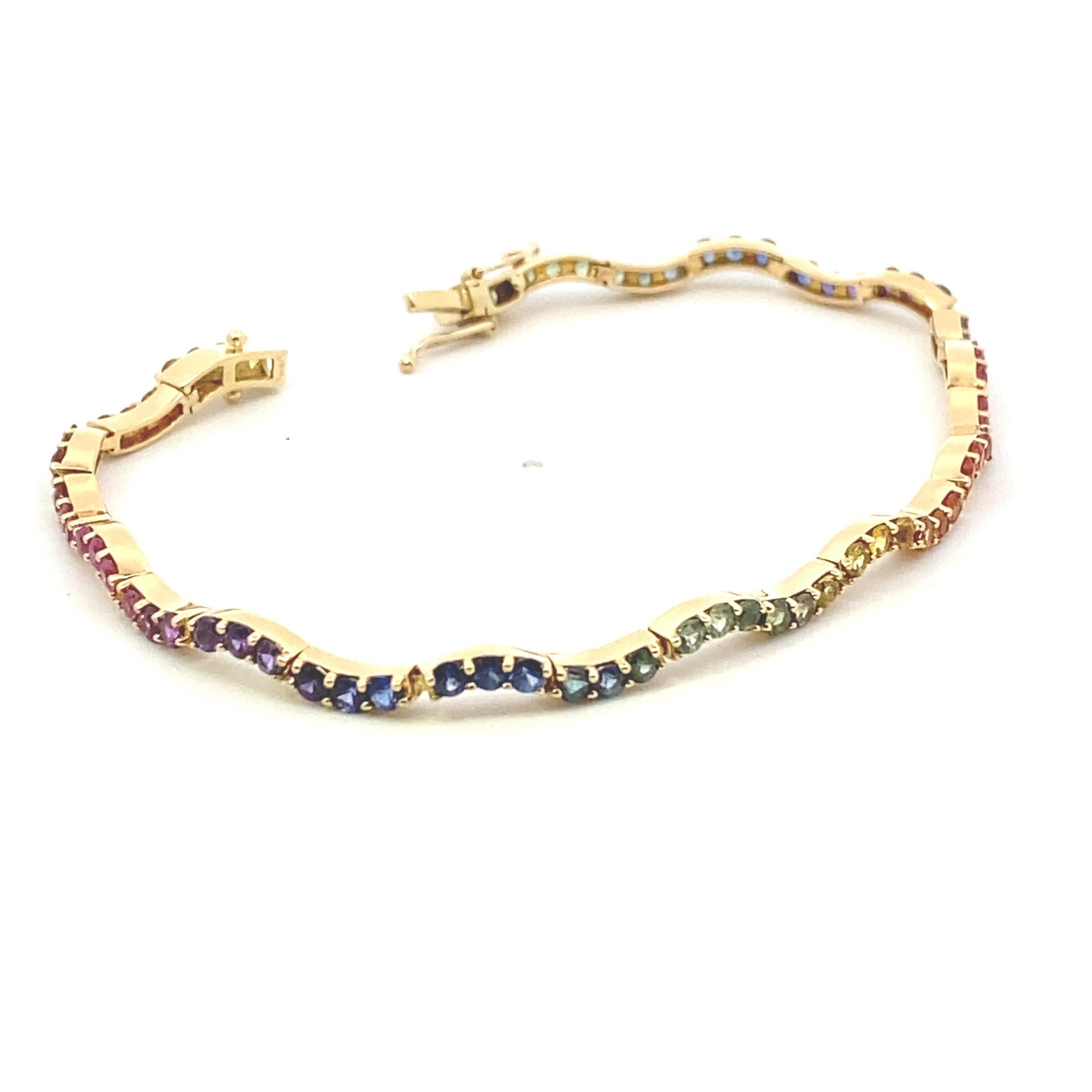 Estate 14k yellow gold 7 inch rainbow sapphire tennis bracelet with 72= 2.88 carat total weight multi-colored sapphires. 