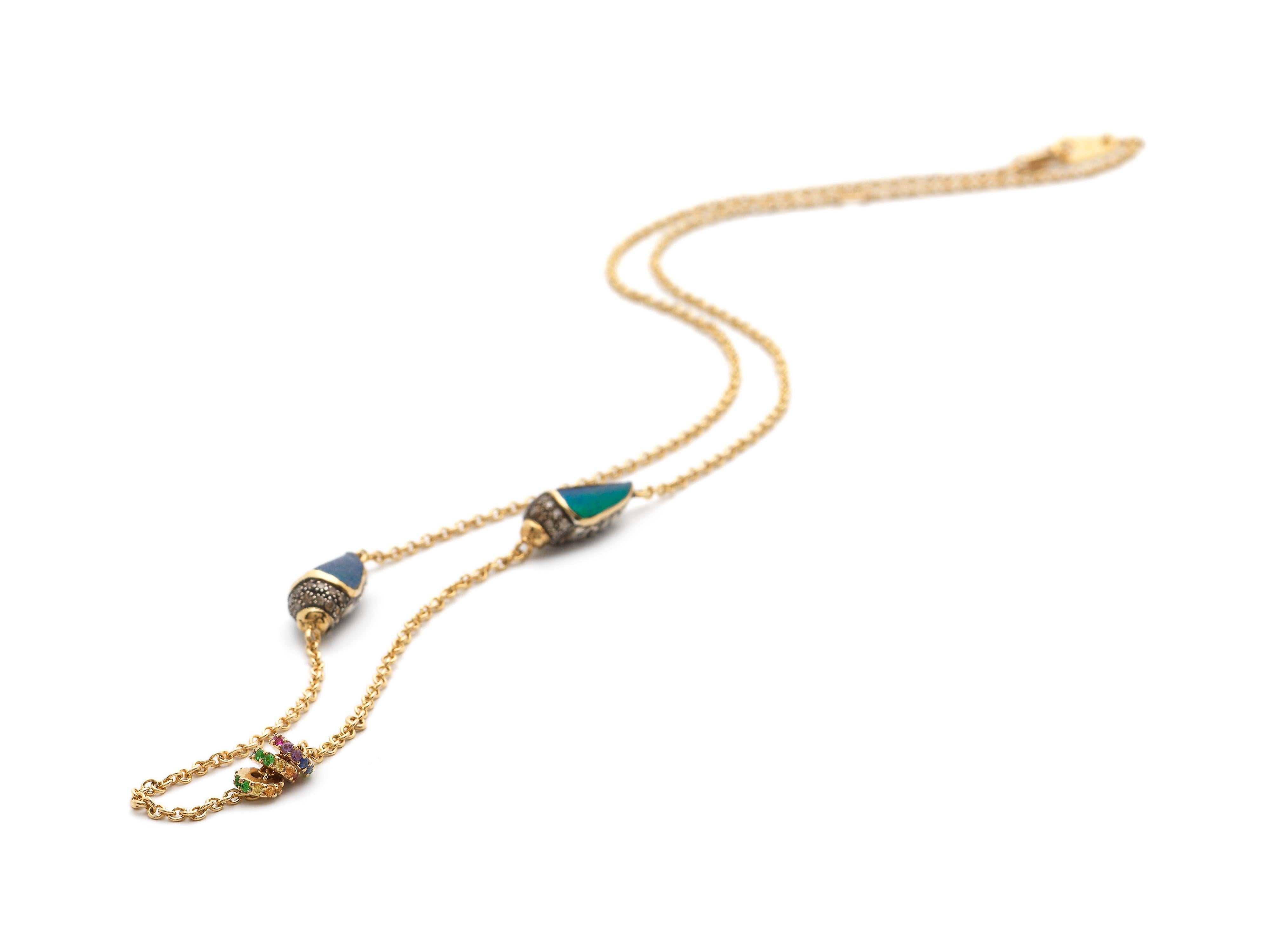 This necklace sits like a second skin on the collarbone. The piece is designed as a fine, 18k yellow gold chain on which sit two sterling silver scarabs, set with real scarab wings and embellished with brown diamonds, tsavorites, and multi-coloured