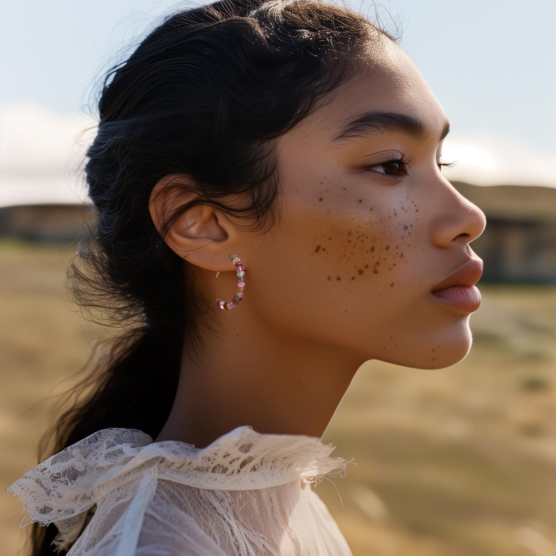 Slip these rainbow tourmaline hoops on and feel instantly radiant—like a beam of joy framing your face. Every stone holds a whisper of color and character, reminding you to express yourself boldly, beautifully, and unapologetically. They’re not just