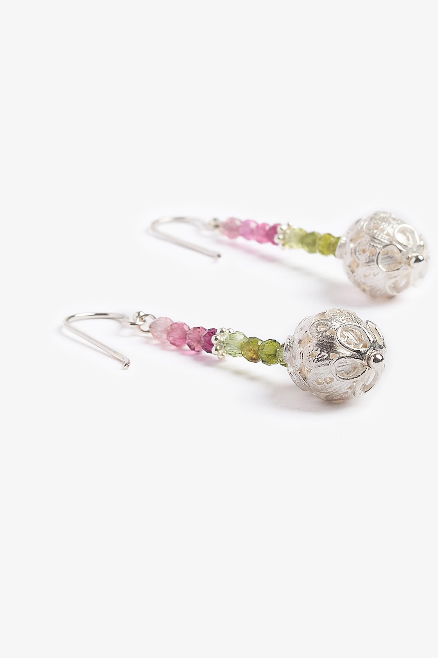 Rainbow tourmaline is a precious and protective stone.  Its vibrant colors represent that of a rainbow.  It is a stone that promotes joy and happiness and is also known for protection and restoring balance.  The unique sterling silver ornate balls