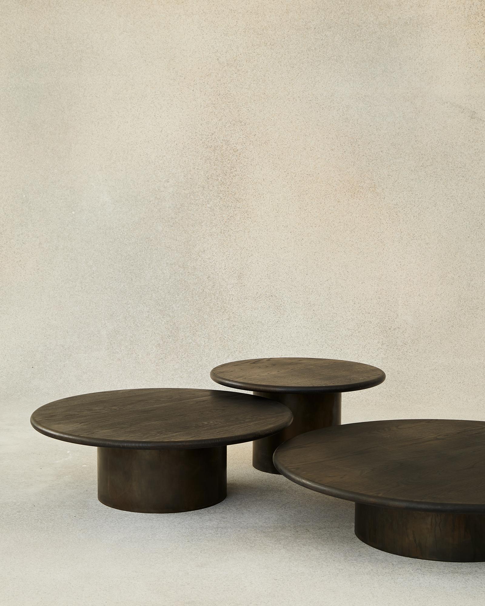 With their circular profiles, varying proportions and potential to be nested, these versatile tables evoke the pattern of raindrops in a pool of water when placed together.

Bought as a set of 600, 800, 1000, we add a 10% discount.

Tops: black