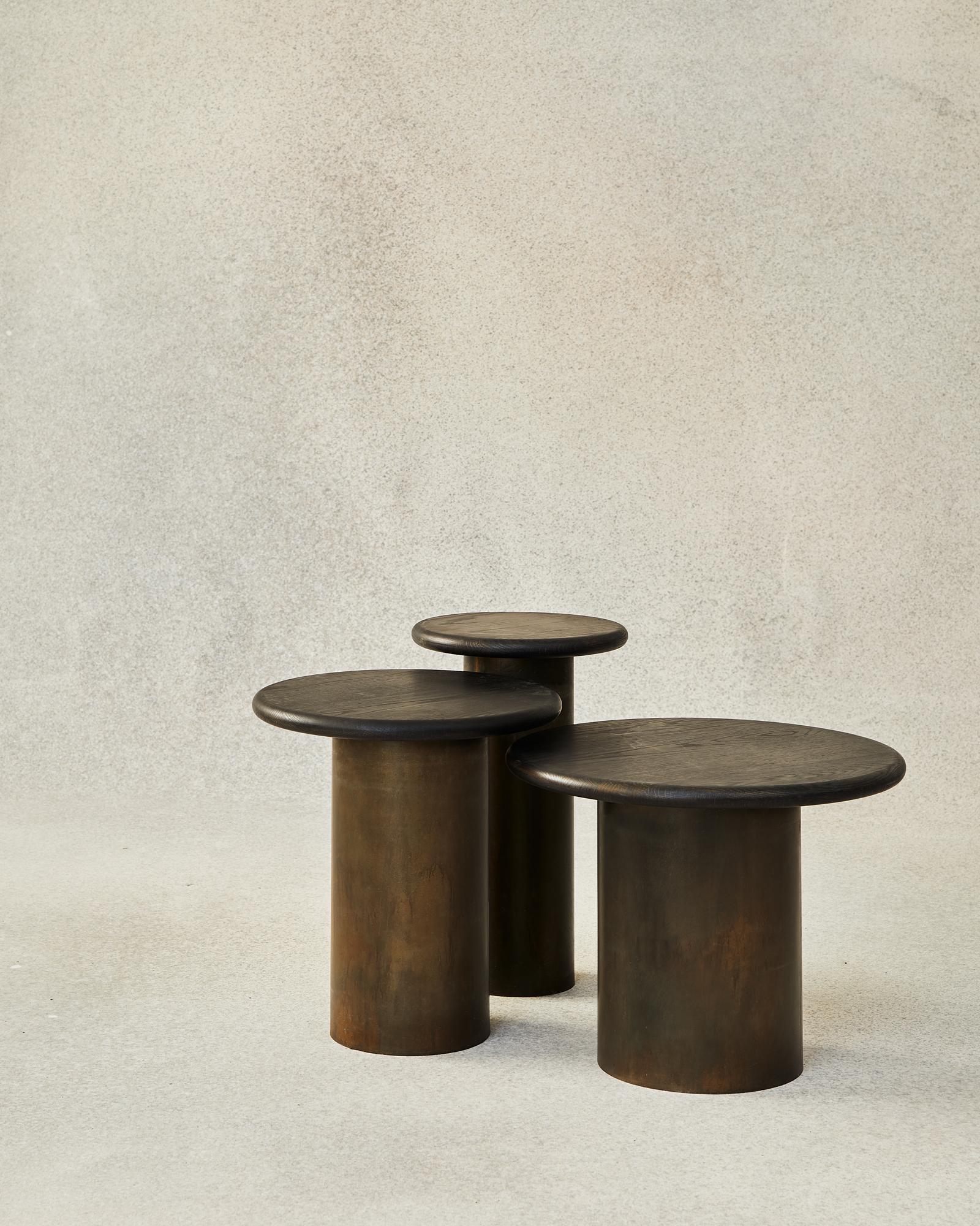 With their circular profiles, varying proportions and potential to be nested, these versatile tables evoke the pattern of raindrops in a pool of water when placed together.

Bought as a set of 300, 400, 500, we add a 10% discount.

Tops: black