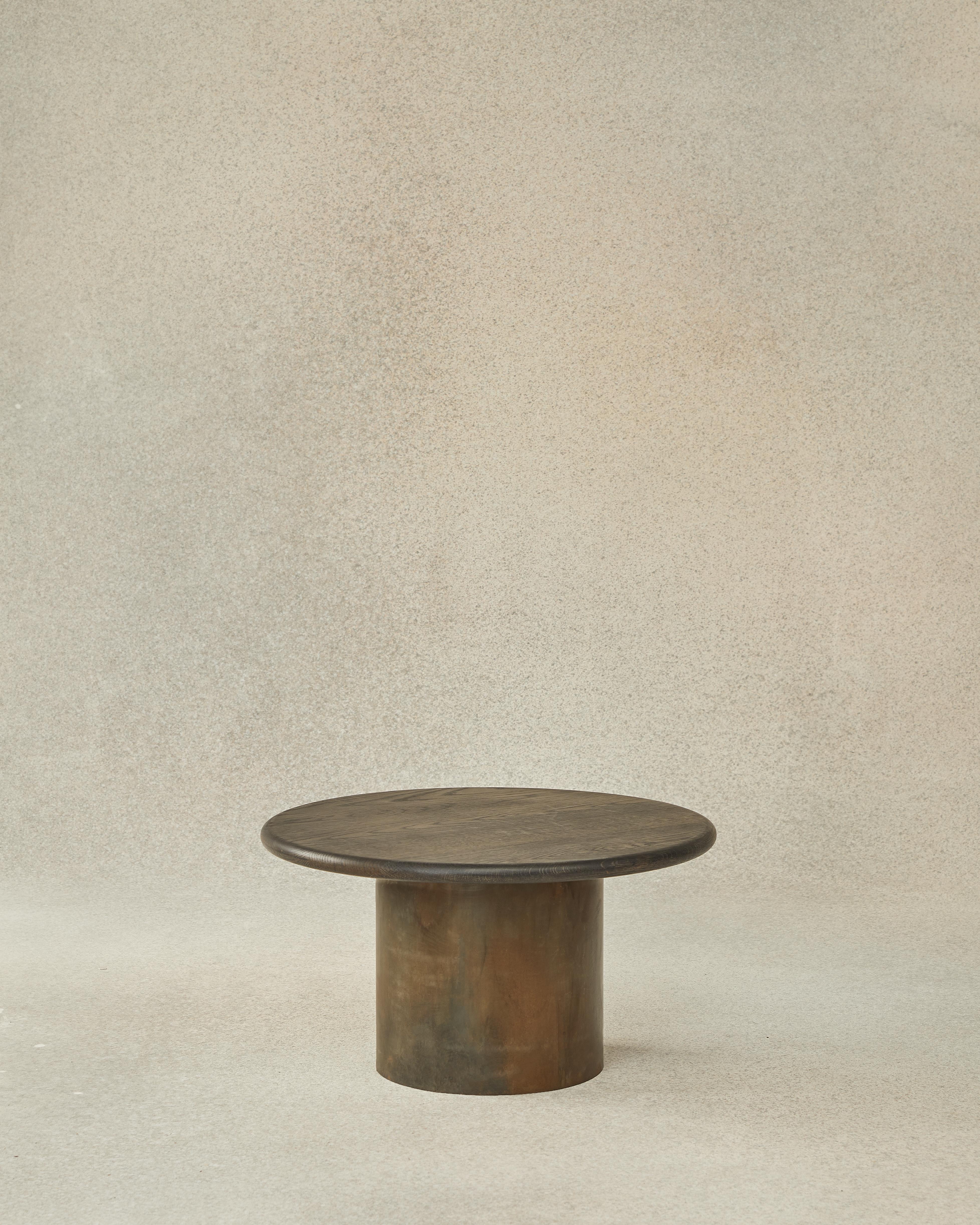 Raindrop table 60 by Fred Rigby Studio
Dimensions: L 60 x W 60 x H 32.5 cm
Materials: Solid oak with rolled mild steel base
Finish: Black Patina
Other dimensions and top finishes available.

Fred Rigby Studio is a London-based furniture and