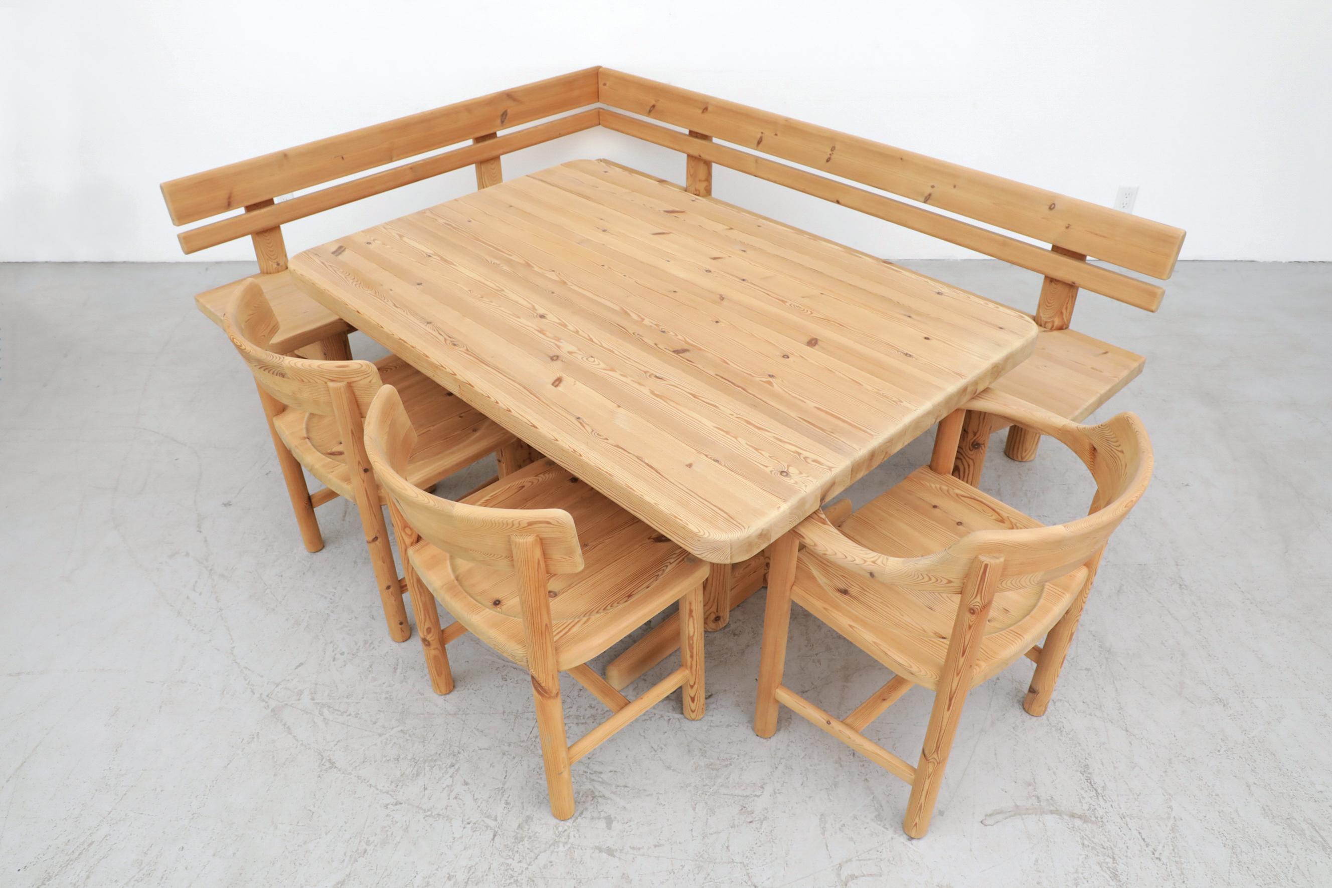 Stunning Rainer Daumiller carved pine dining set consisting of two benches that clip together, two side chairs, an armchair and an impressive dining table. A solid, sturdy set with beautiful wood grain, made by quality craftsmen. In good original