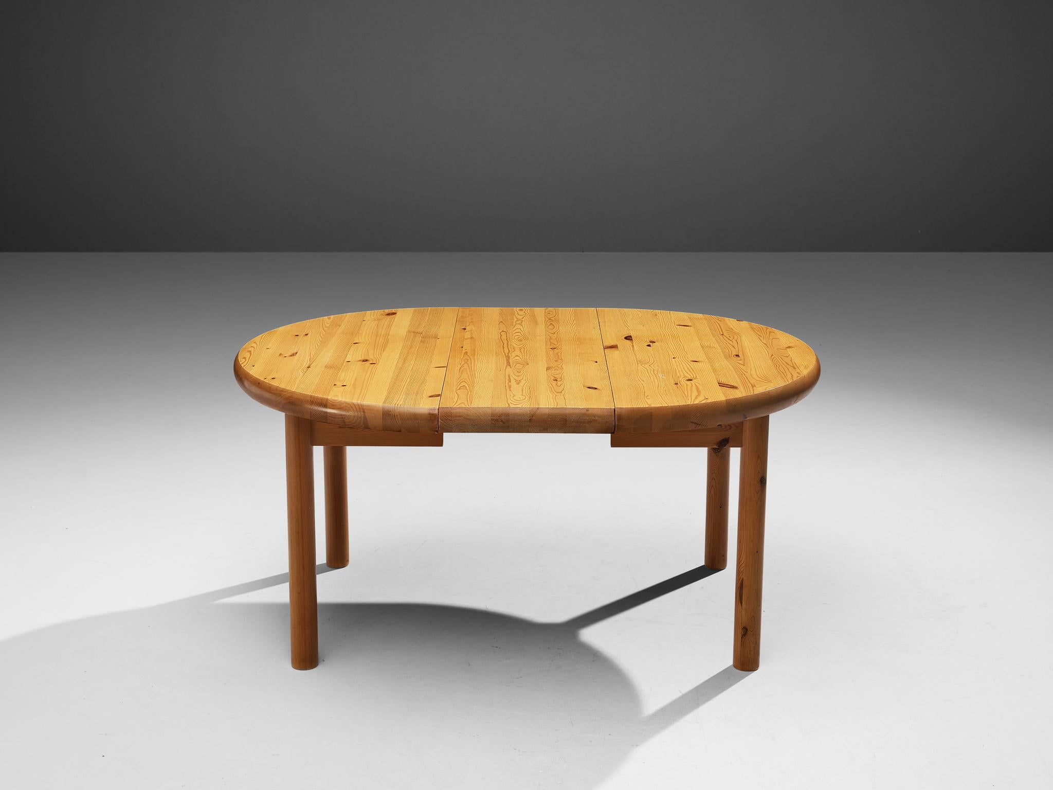 Rainer Daumiller, extendable dining table, pine, Denmark, 1970s.

Robust dining table in solid pine, designed by Rainer Daumiller. A functional design that features a rounded tabletop when not extended and an oval top when one leaf is added to the