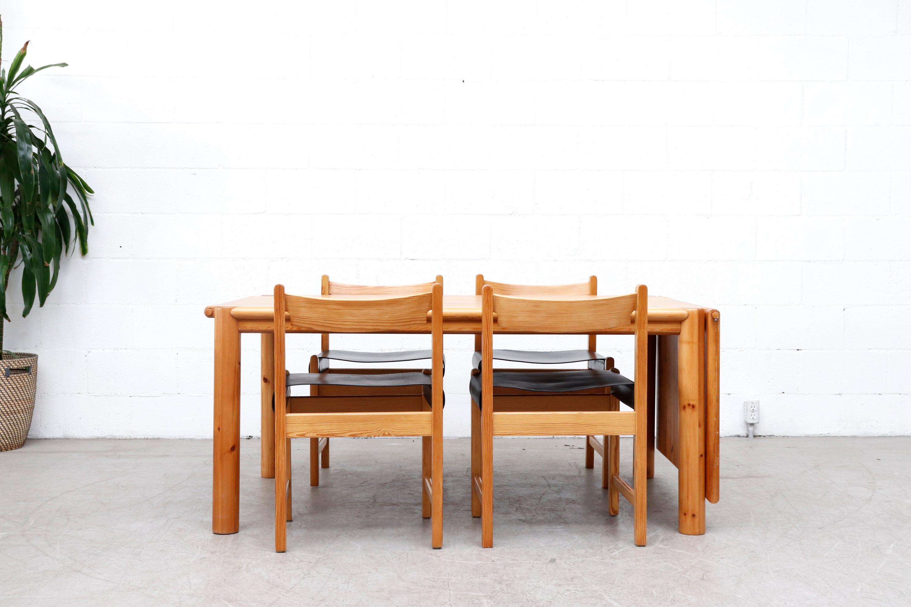 Gorgeous pine dining table by Rainer Daumiller for Hirtshals Savvaerk, Denmark. Lightly refinished rectangle dining table with one single removable leaf and fat round legs. Leaf can be placed on either side of the table with matching wood pegs. In