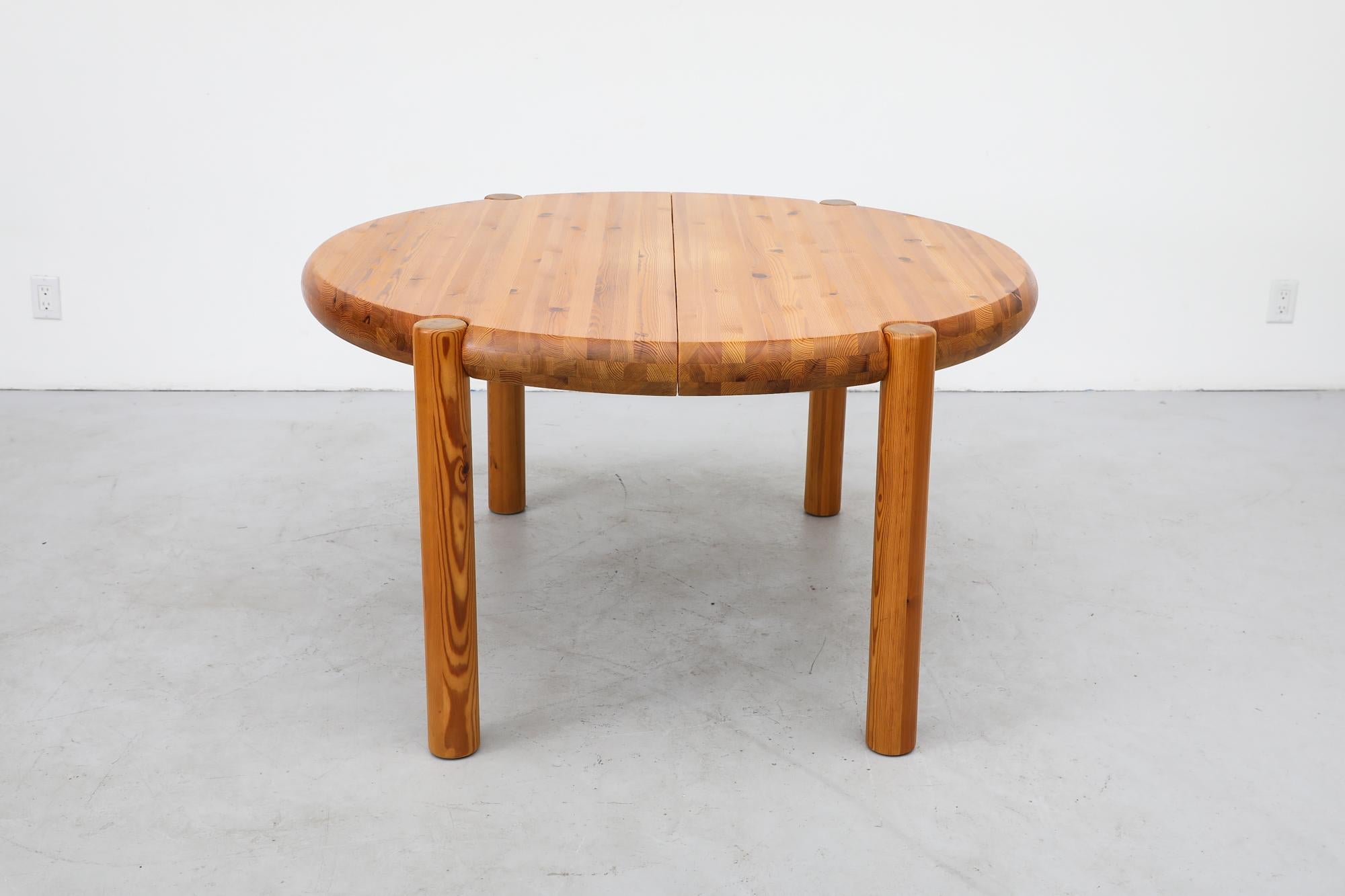 Mid-Century Rainer Daumiller designed, round solid pine dining table with chunky round legs and room for leaves. We do not have leaves for this table at this time. Lightly refinished in otherwise original condition with visible wear and patina