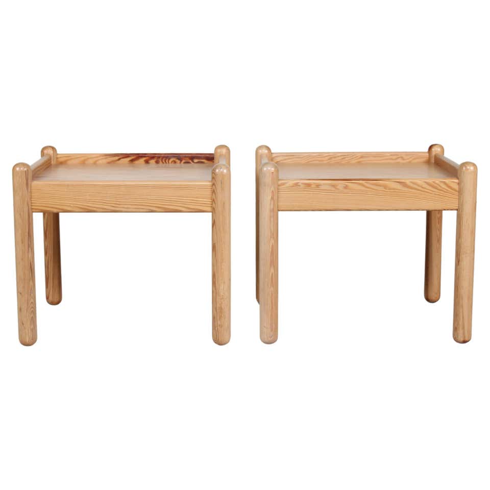 Pair of solid pine stools / side tables with cylindrical foot rail c ...