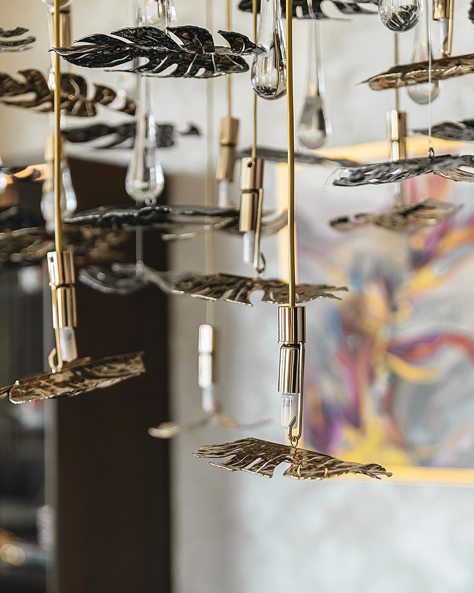 Inspired by the serene beauty of a rainforest, this suspended chandelier features handcrafted, gold-plated brass leaves paired with crystal accents. Each element is meticulously designed to evoke the organic elegance of nature, with a cascading