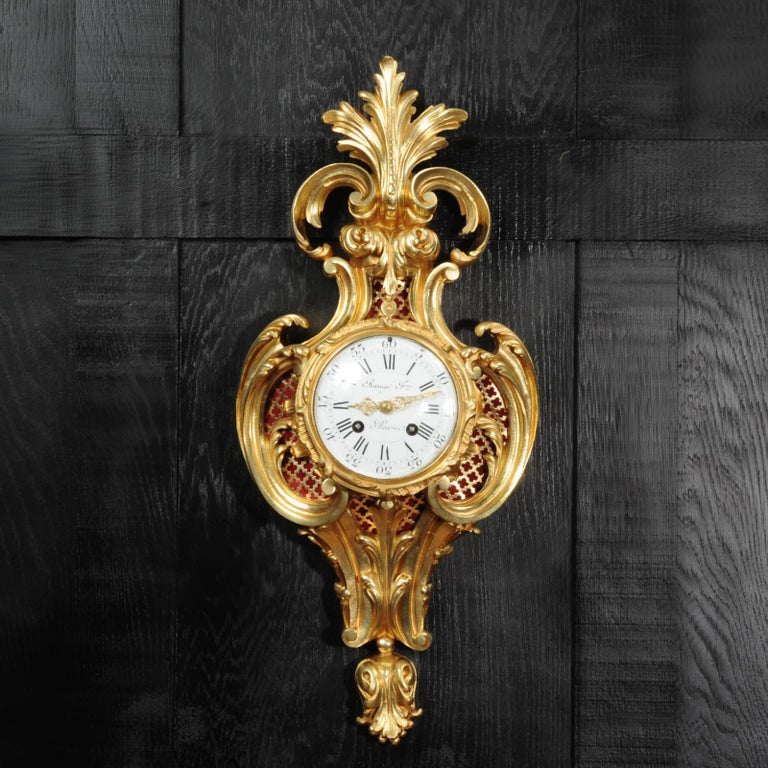 A stunning original antique French cartel wall clock by the famous Parisian maker Raingo Frères with the movement by Japy Frères. It is Louis XV in style, circa 1880, the Rococo case formed of sweeping 'C' scrolls and acanthus. It is heavily