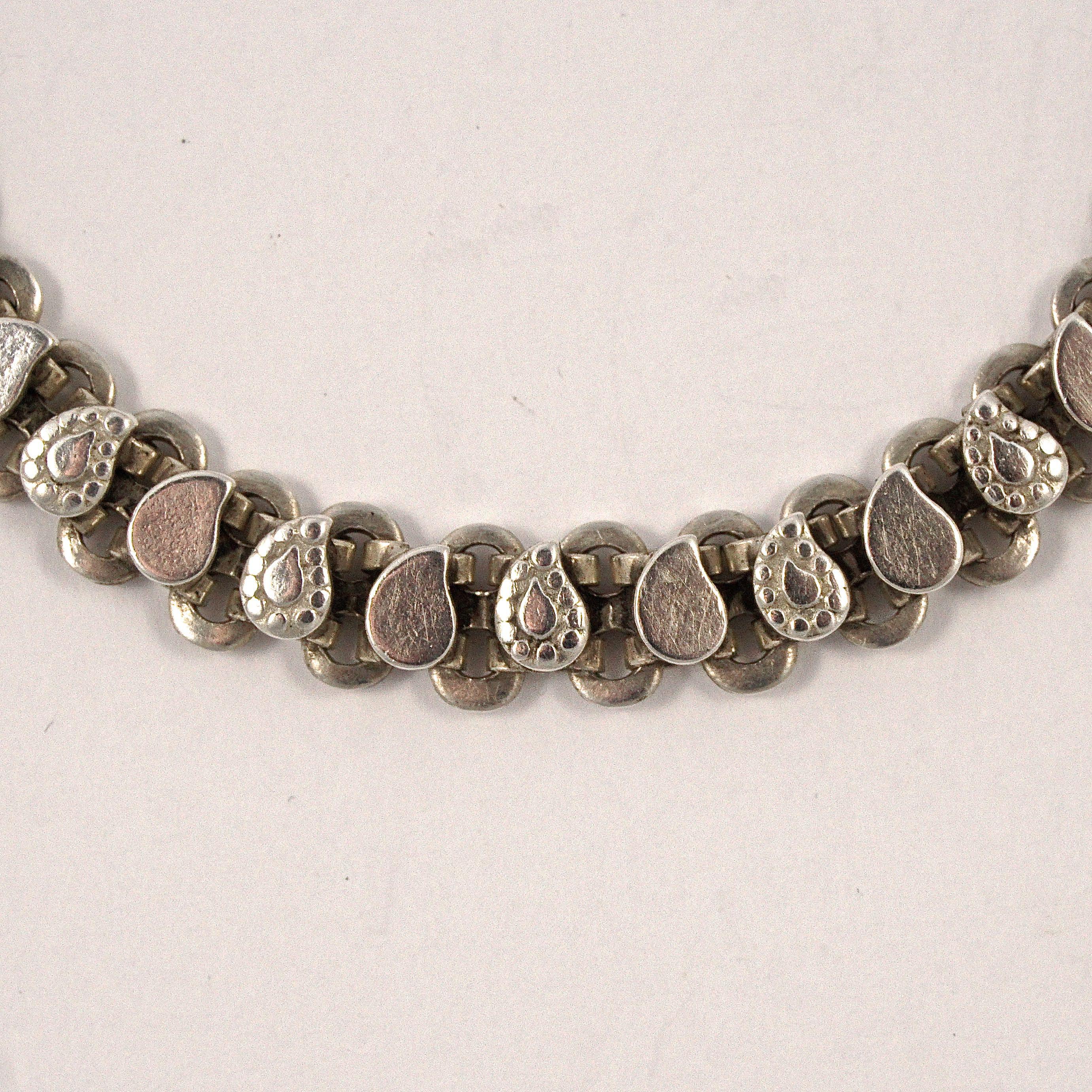 Rajasthan, India, silver chain bracelet with a simple hook fastening. The links have alternating smooth and patterned decorative links. The bracelet is stamped RA and tests for silver. Measuring length 20.3cm / 8 inches by width 7.75mm / .3