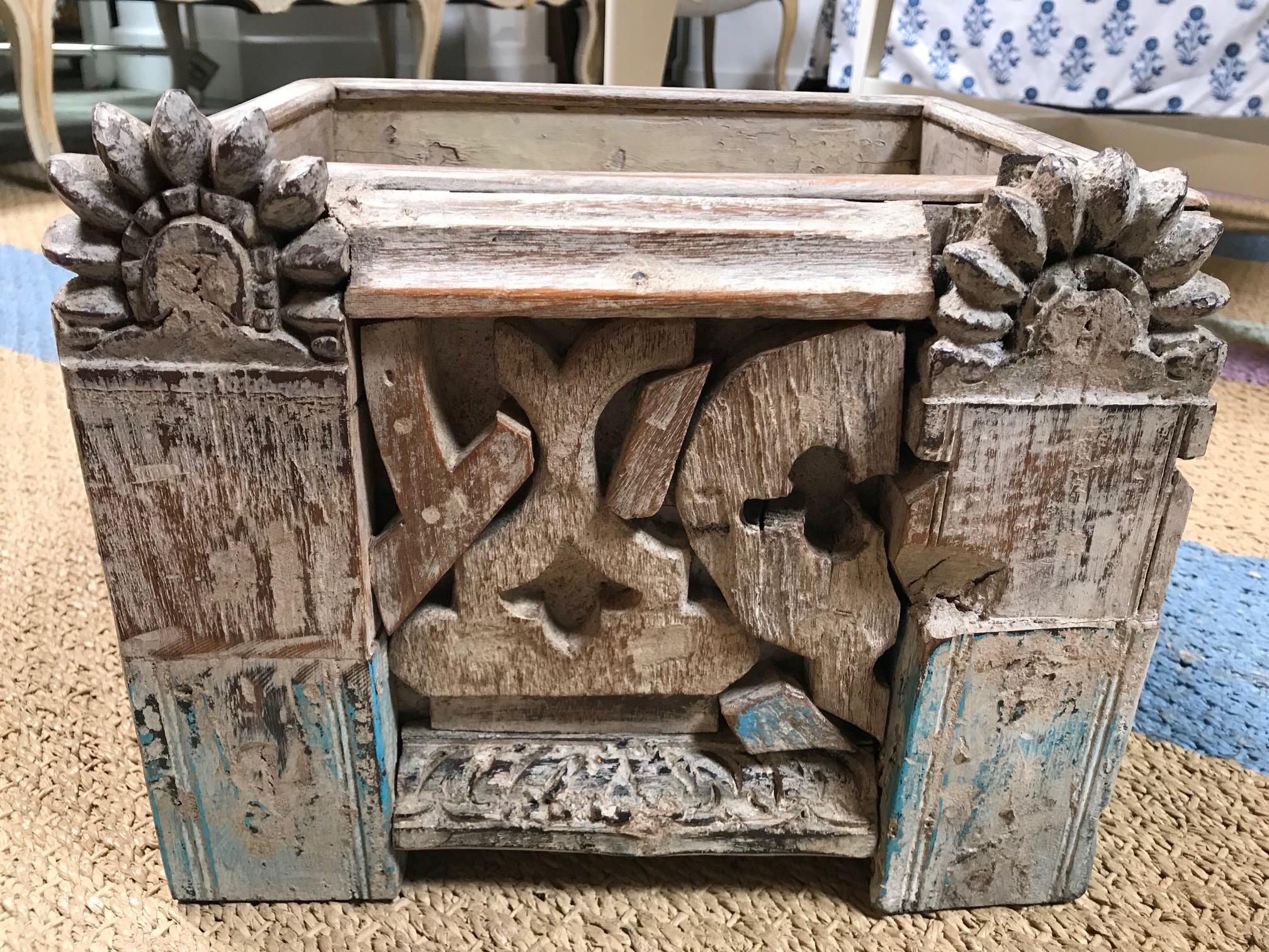 This sturdy box is slightly waxy to the touch. Giving light to the olden way of preserving carved wood. There are blue pieces to this box that give off a cultural and exotic feel. The front facade is pieced together with remnants of another life.