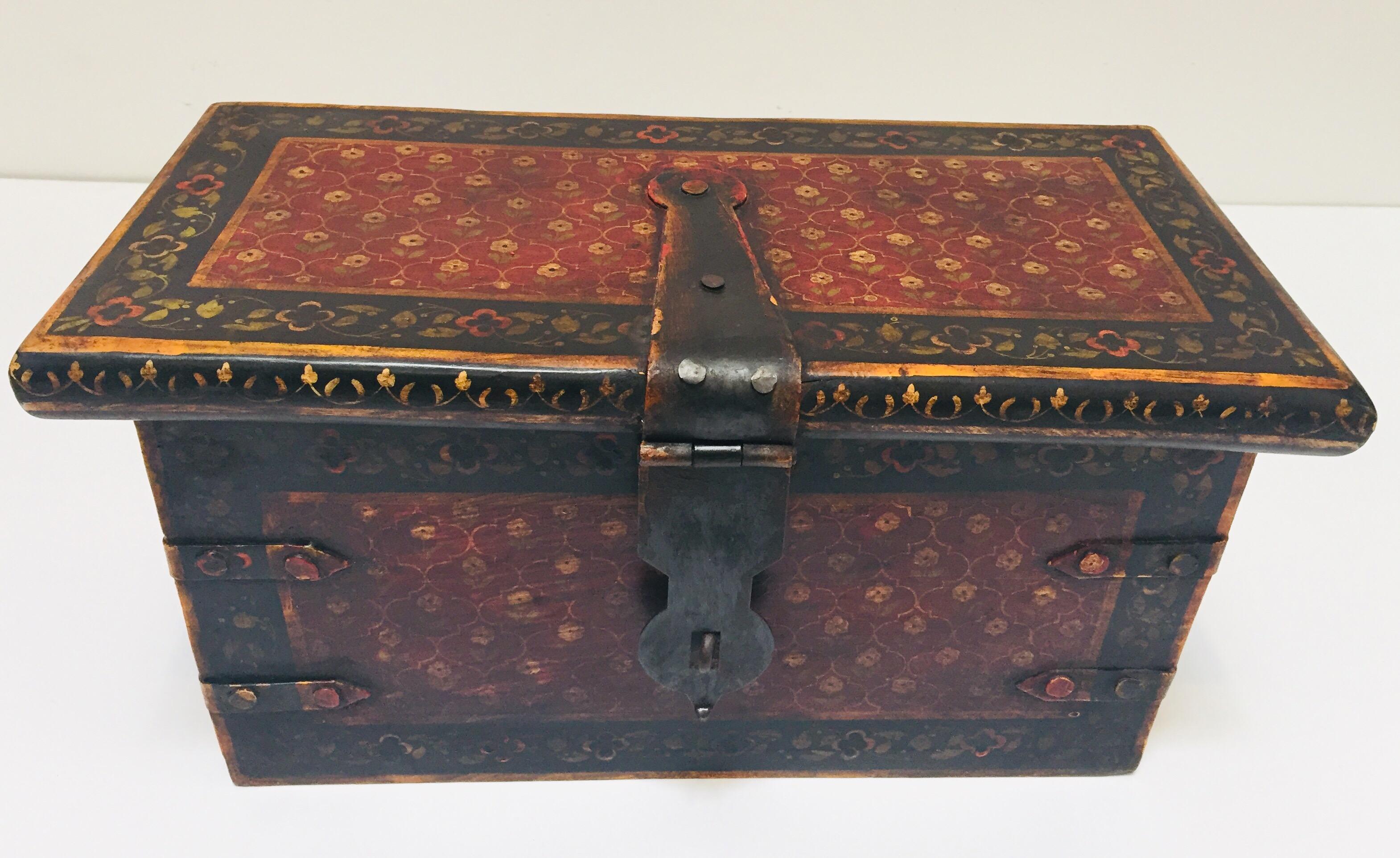 Hand painted Rajasthani large decorative coffer trunk.
Rajasthani Indian hand painted jewelry dowry box.
Hand painted rectangular shape wood box with hinged lid and decorated with floral designs in red and black.
Wrought iron central hasp to open
