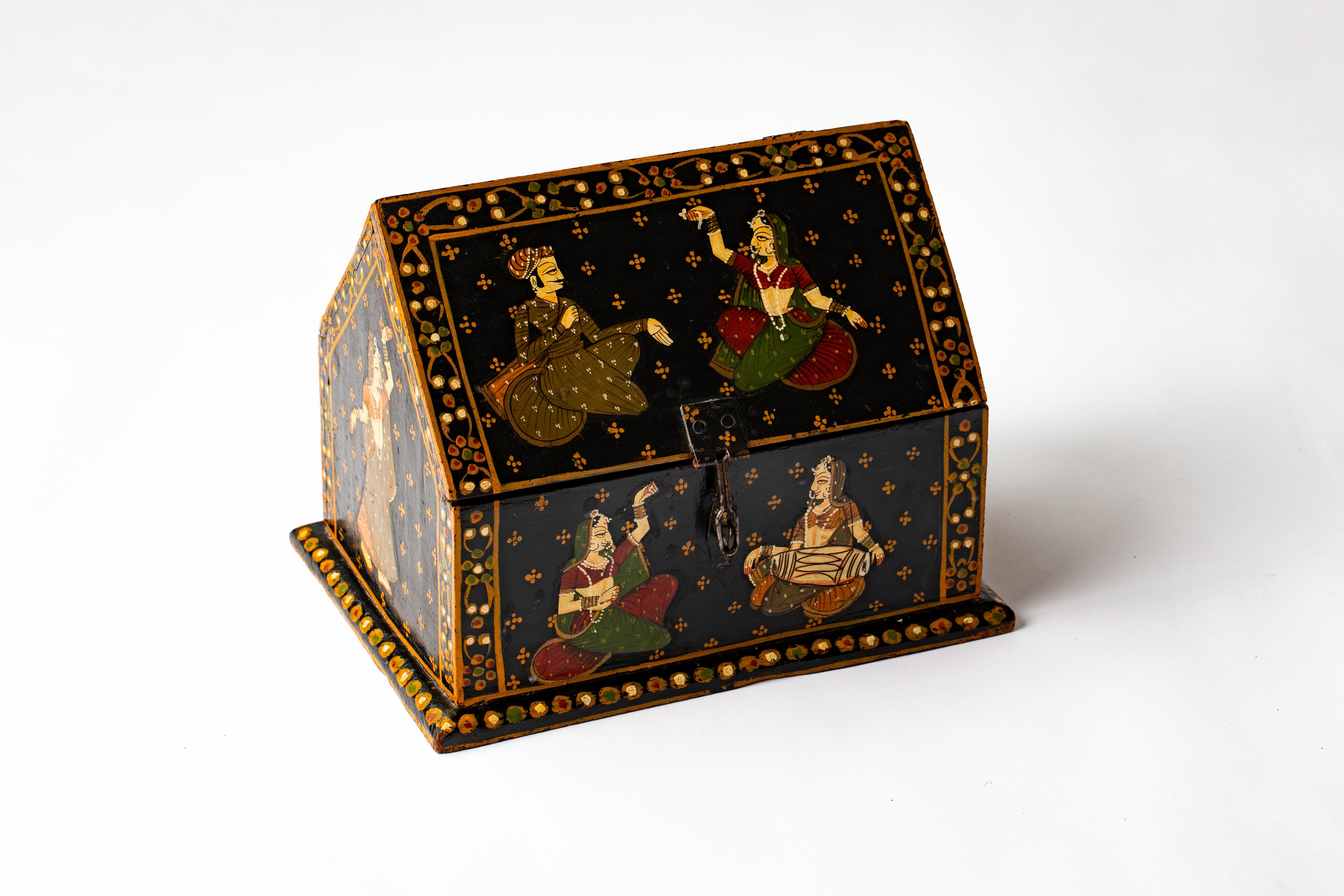 Vintage Rajasthani Indian vaulted dowry jewelry box, hand painted with Indian lovers enjoying each other, while beautiful court musicians accompany them musically, setting the tone for love. Wrought iron central hasp to open and close box. Red