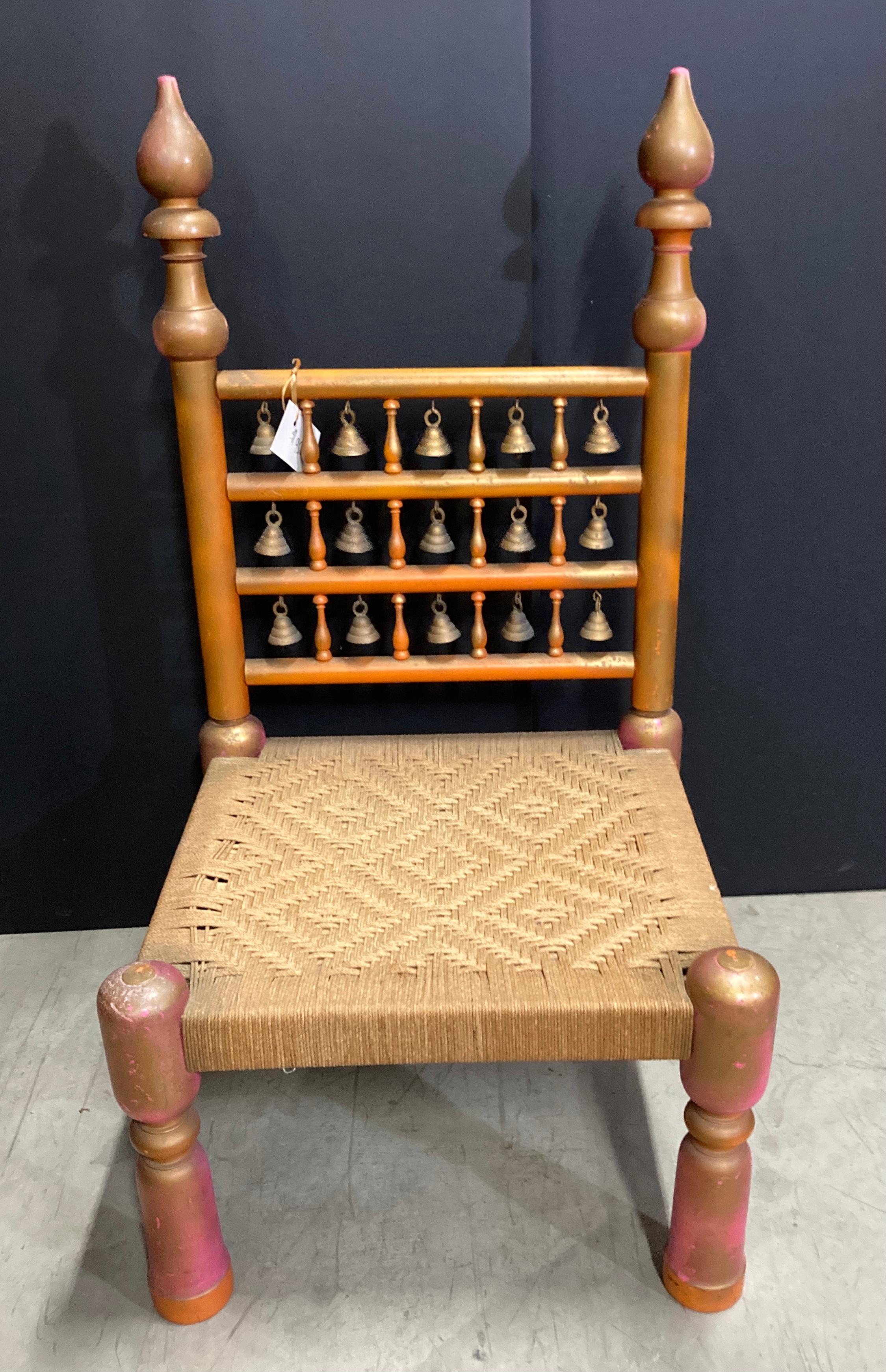 Rajasthani low Moorish chair with happy colors, pink orange and gold, with small brass bells and cane seat.
Great for kids, Moroccan room or a yoga room.
Midcentury low chair with rope seat handcrafted in India.
The chair features four turned legs