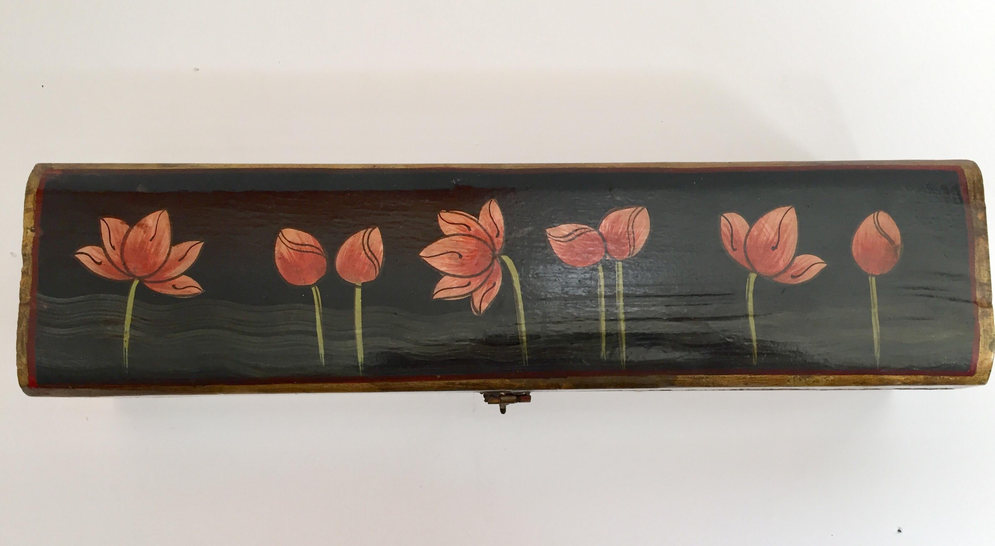 Hand painted Rajhastani decorative writing box.
Hand painted wood in rectangular shape with hinged lid and decorated with floral designs on black.