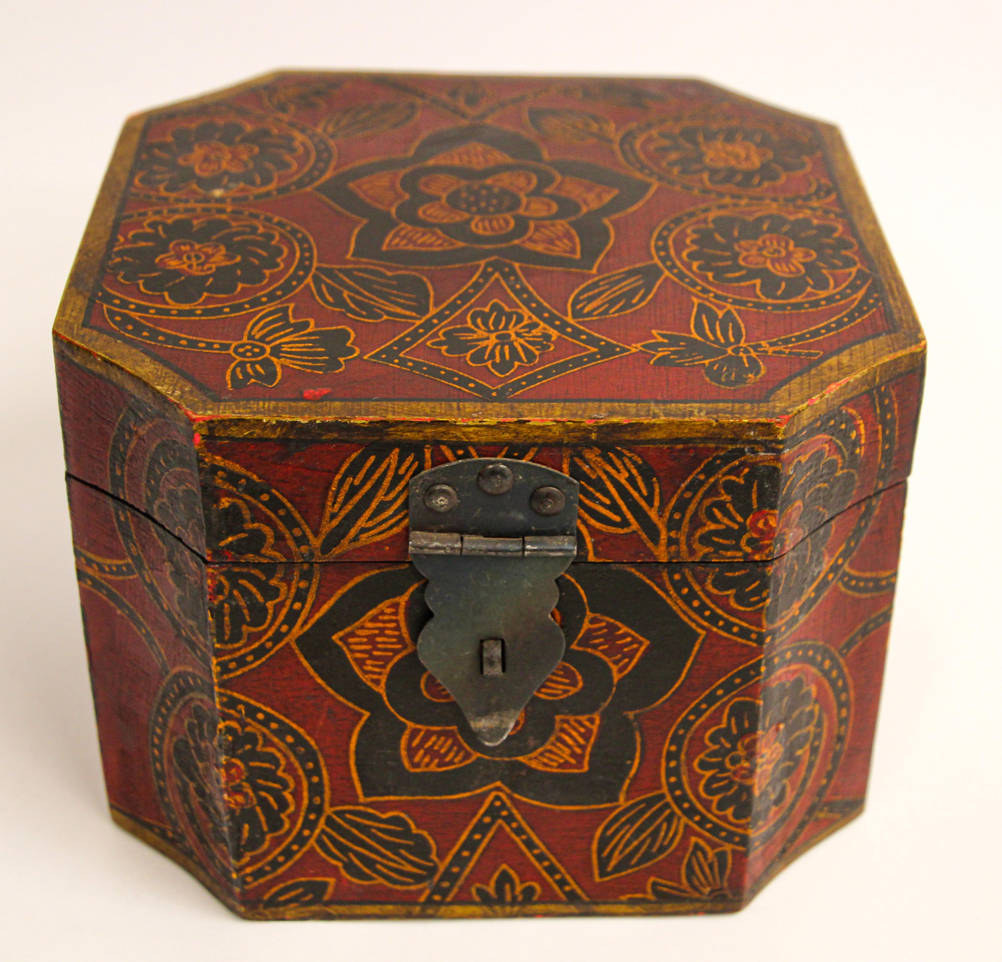 Hand painted Tibetan decorative jewelry box.
Hand painted wood in an octagonal shape with hinged lid and decorated with vibrant floral designs on black.
A vintage Tibetan wood box, exquisitely painted with flowers in black and mustard on a dark