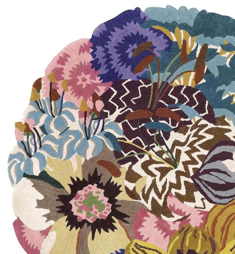 Dazzling and eclectic, this superb rug will be a bright and unmistakable accent in any entryway, bathroom, or bedroom decor. Transforming opulence into art, this pure-wool rug boasts a striking array of multicolored flowers, from sunflowers and