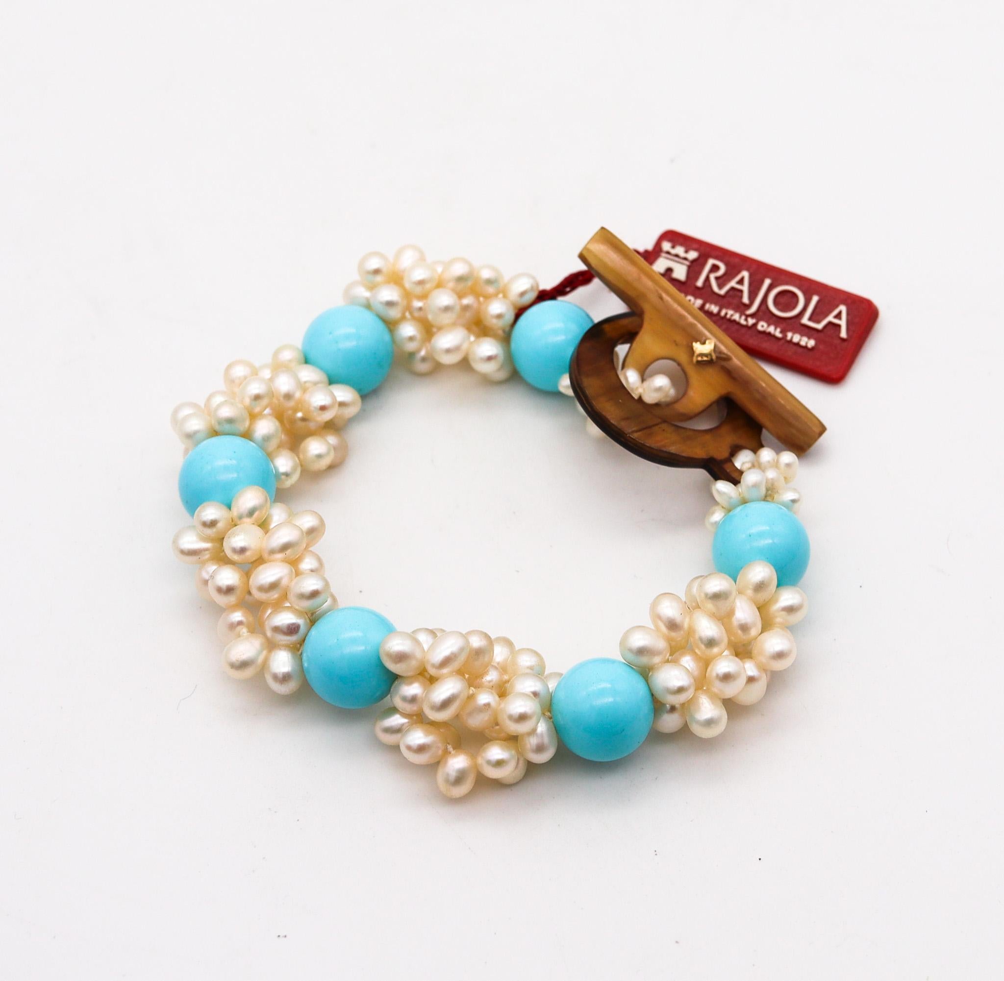 A bracelet designed by Rajola.

Beautiful contemporary bracelet, created in Italy at the atelier of Rajola. This piece is composed by multiples cultured pearls and six spheres carved from blue turquoises and is fitted with a toggle lock carved from