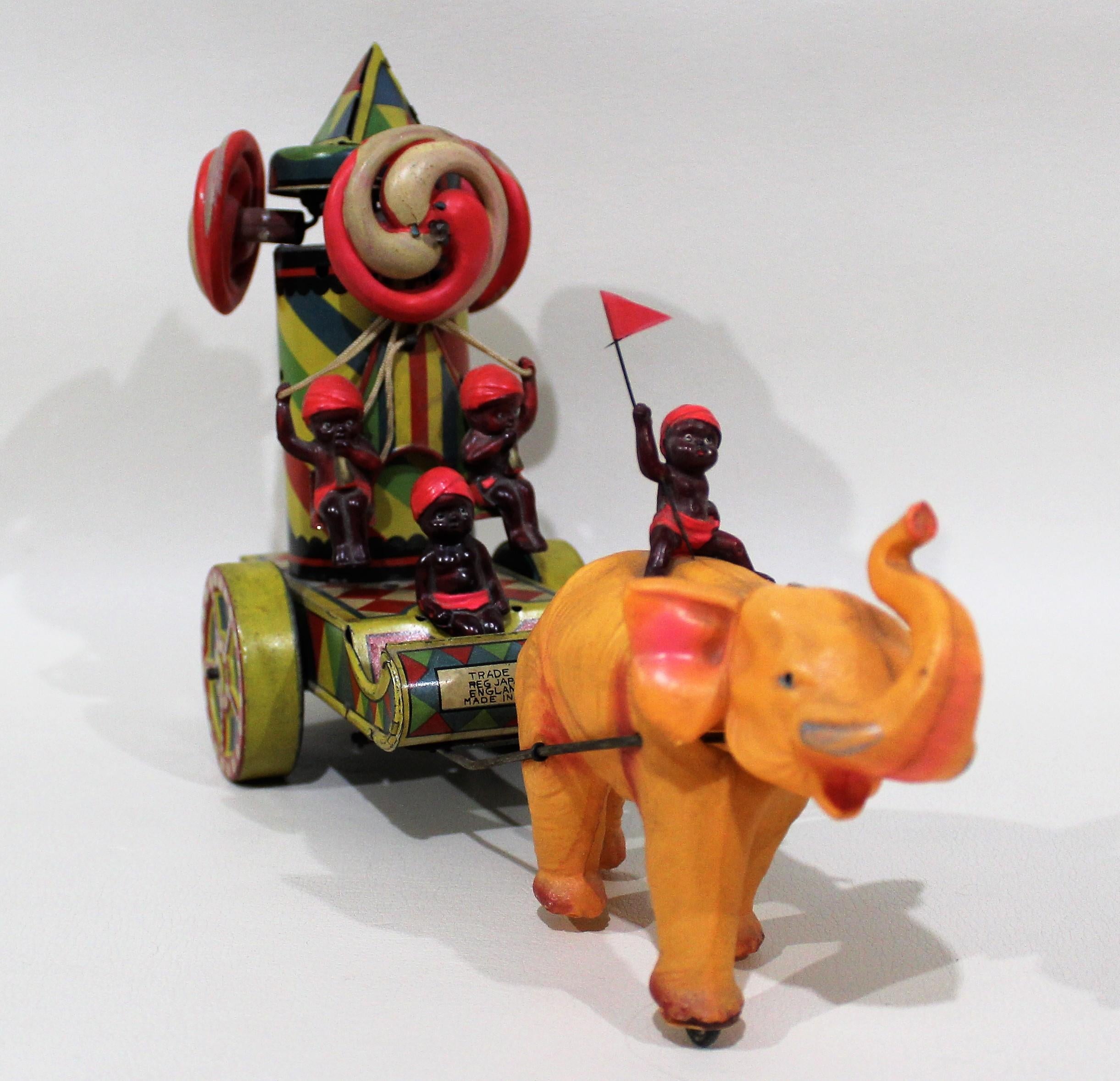 Vintage Japanese tin and celluloid wind up toy. When you wind this toy the top spins around while the babies on the back move from side to side and the elephants head also wiggles.