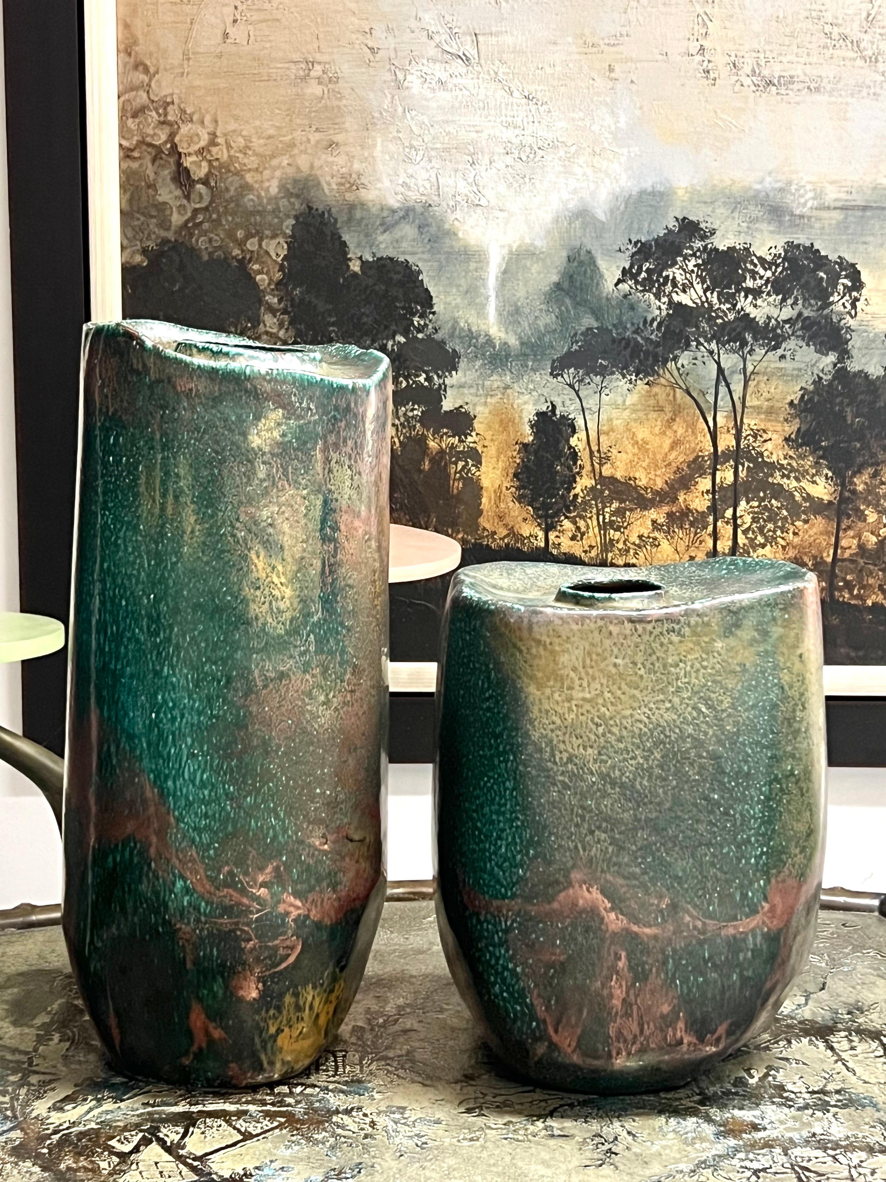 A pair of Raku ceramic Vases by Tony Evans. Exquisite glazes. 
The shorter one measures 16” high, 11.5 wide and 9” deep. 