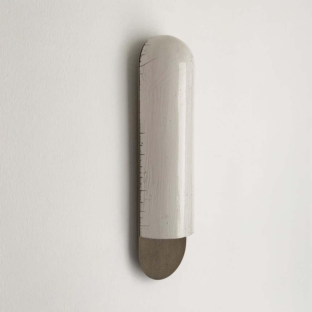 A sconce in patinated pitted brass and Japanese ceramic raku-yaki
Discover this elegant sconce which celebrates the Japanese minimalistic philosophy and enlighten your interior with refinement and a sense of craft.

This regular version is a
