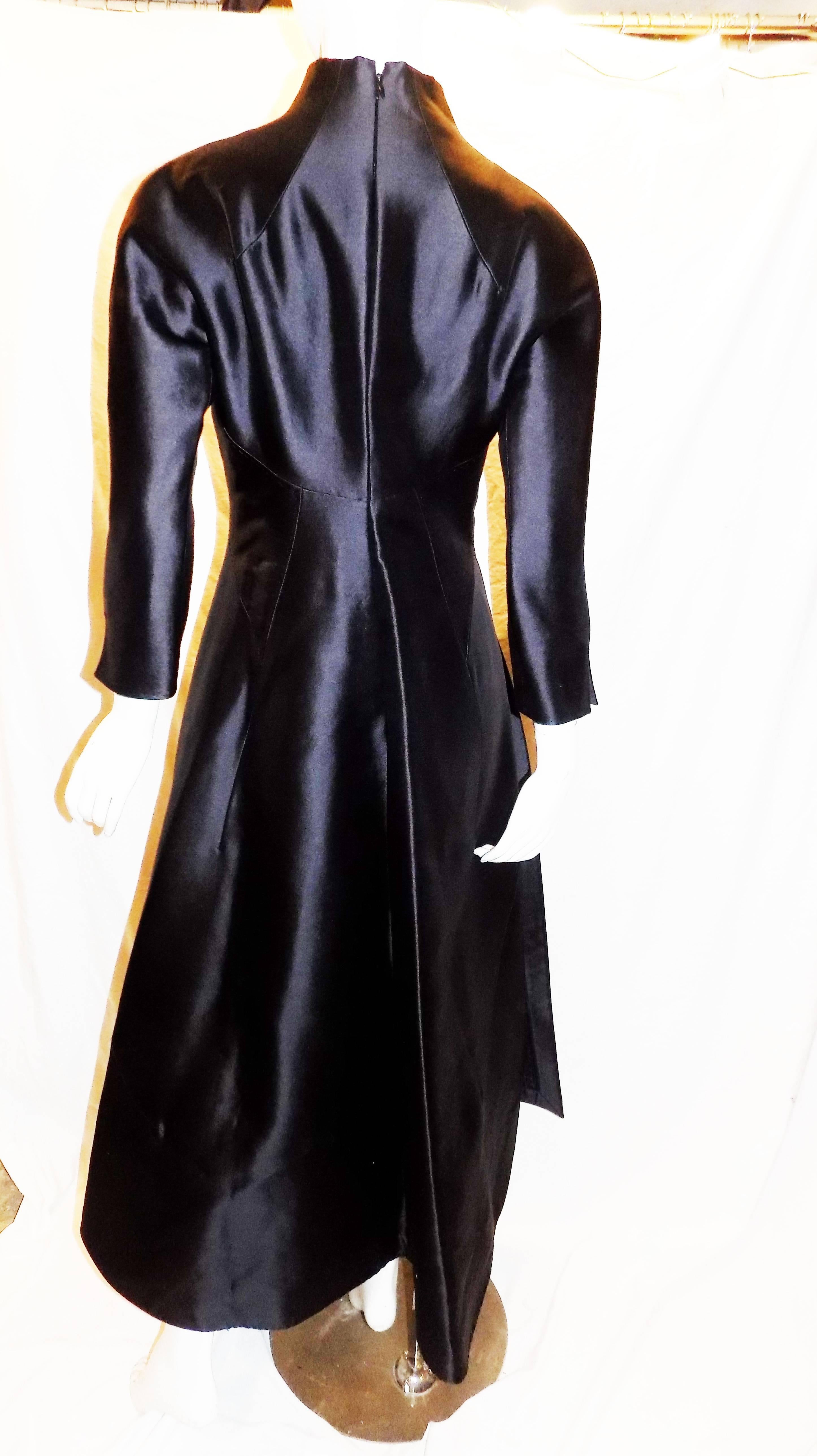 Beautifully structured black silk gown by Ralph Rucci. A line  High  low skirt part with fitted top and waist line.  Structured front loose  panel with hidden pocket under . Back zipper closure.  Never worn in Pristine condition!!  Size 10 but