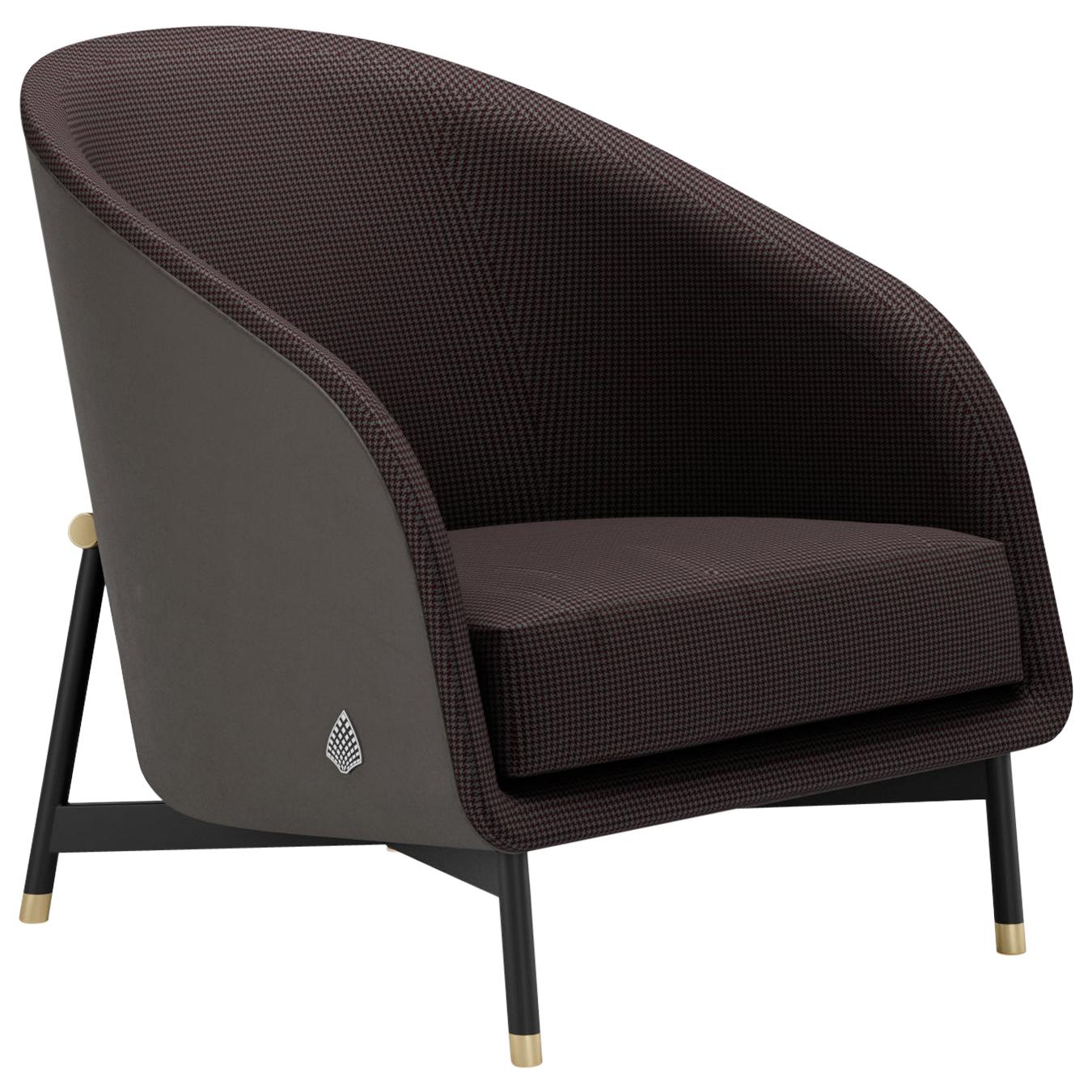Ralph is one of the two armchair from the Hoffman collection. The hard wooden body, is covered in leather from the outside, hugging the padded fabric upholstery backrest covering. The whole structure is elevated by a metal frame the keeps the
