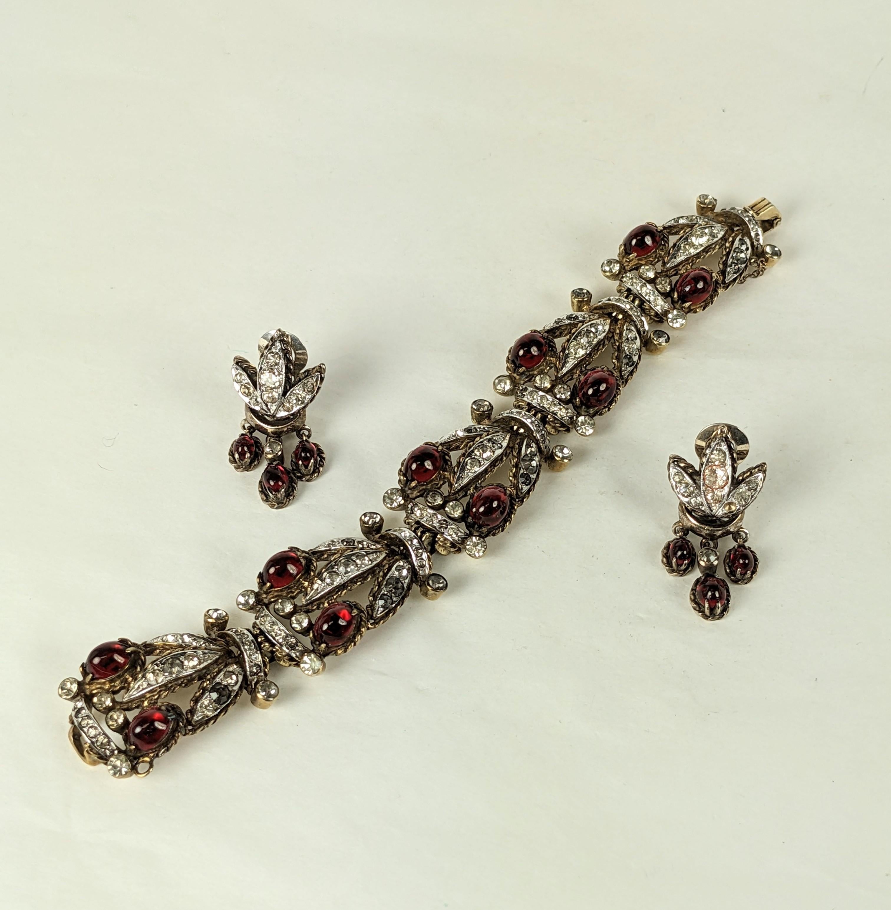 Ralph DeRosa Sterling Retro Vermeil Set from the 1940's. Retro style link bracelet in vermeil sterling with faux ruby cabs and crystal pastes. Clip earrings have dangling ruby pastes to match.
Pastes are set in sterling while the colored stones are
