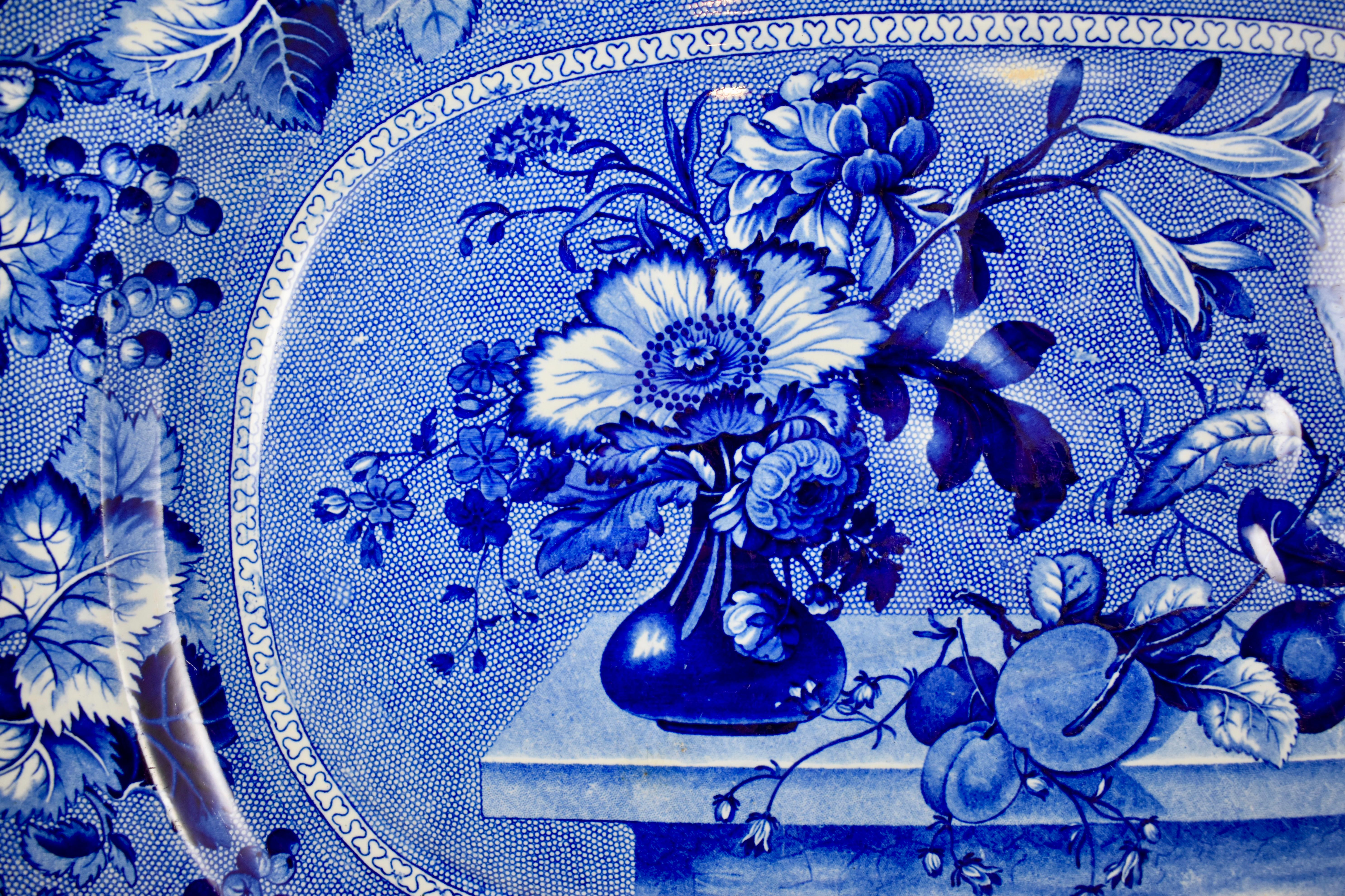 A blue on white, stoneware Staffordshire ‘Coronation’ pattern, well and tree platter by Ralph & James Clews, 1814–1834, Cobridge, Staffordshire, England. 19th Century.

A well-and-tree platter has a depressed design of a trunk and branches through