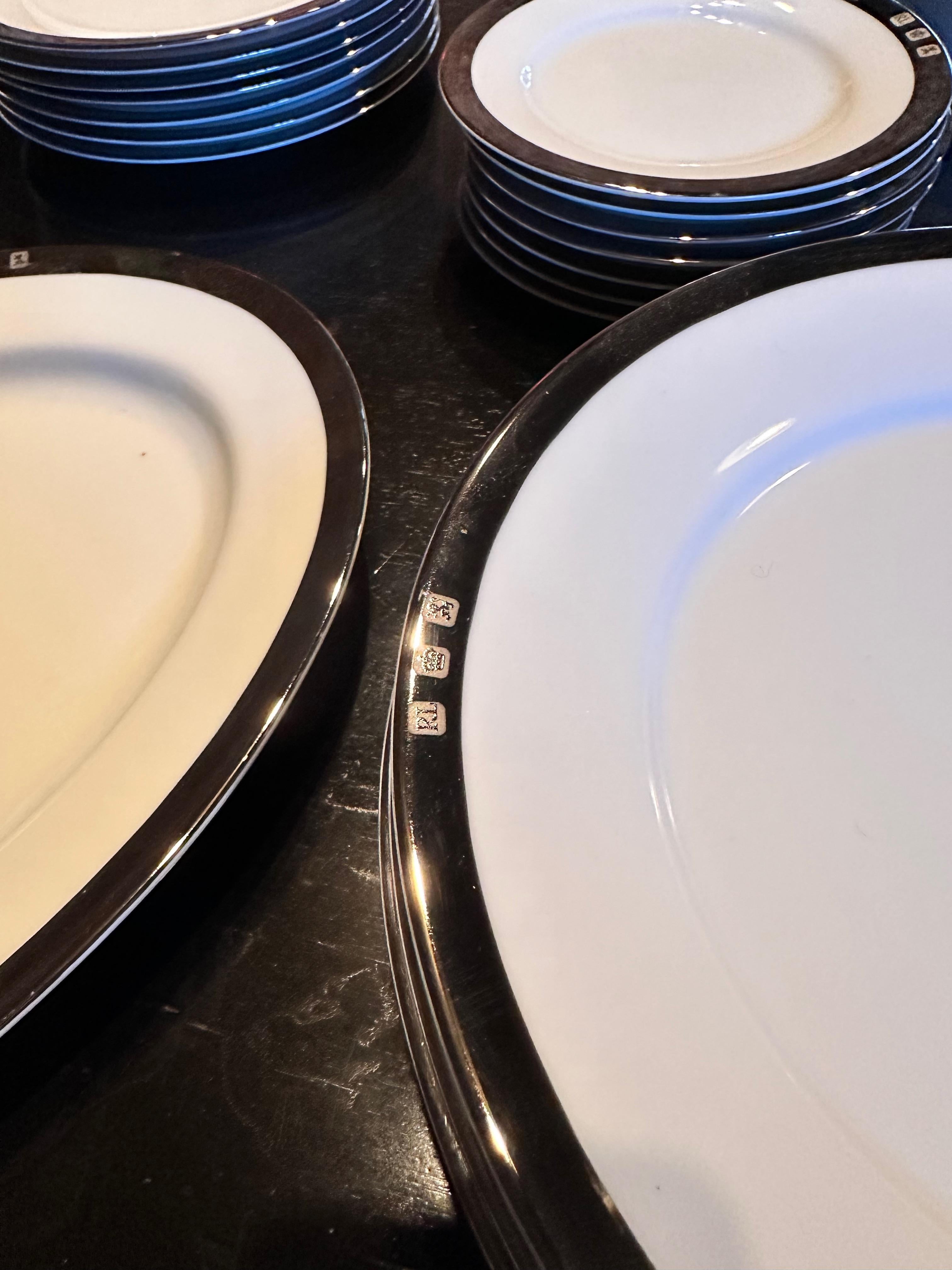 A set of 8 (eight) place settings in the Academy Platinum pattern by Ralph Lauren Home collection. Bone china. Signed. Imported, production period 1995-2002.

Features a platinum/Silvertone border on white.

This set includes:
8 dinner plates
8