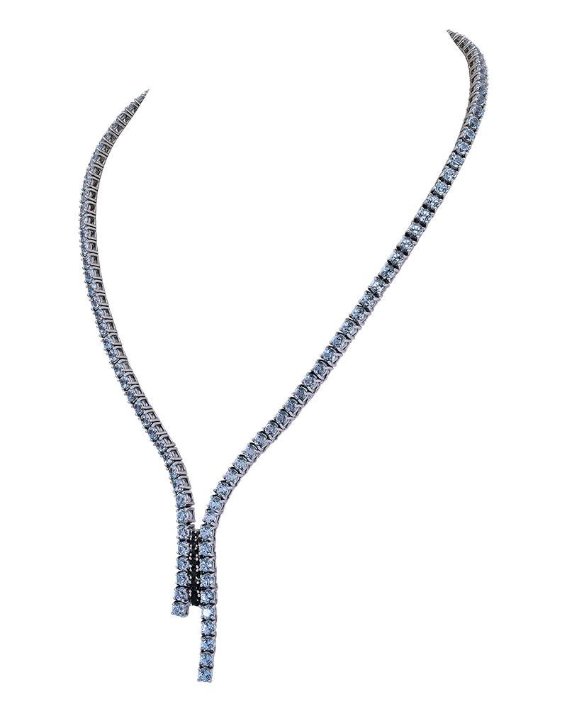 An alluring lariat style necklace featuring 117 round Blue Topaz stones weighing approximately 31.5 carats. 
The center features 8 graduated Green Tourmaline stones weighing approximately 0.50 carats. 

set in 18K Gold, Signed Ralph Lauren