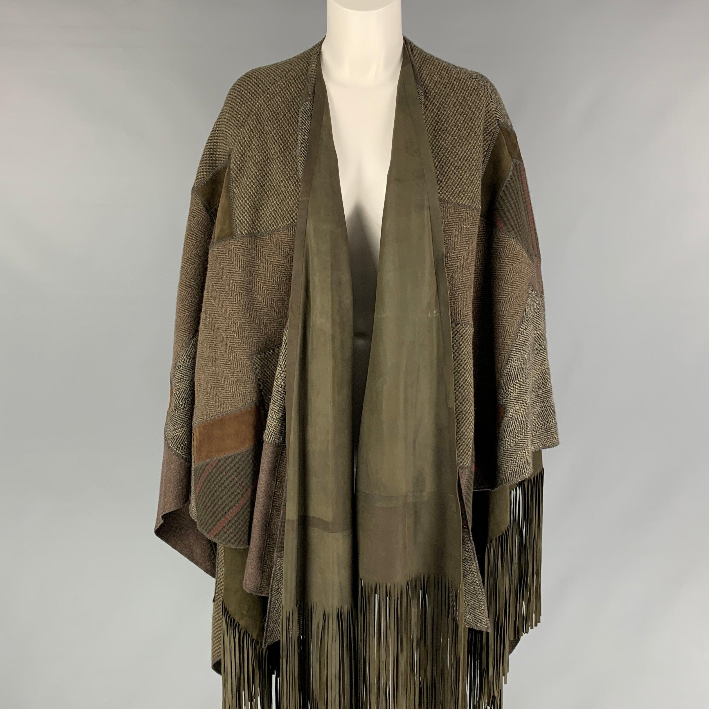 RALPH LAUREN 2016 Collection 'Carlotta' poncho comes in a olive & brown wool featuring patchwork designs, suede fringe trim, and a open front.
Excellent
Pre-Owned Condition. 

Marked:   XS/S 

Measurements: 
  Length: 42 inches 
  
  
 
Reference:
