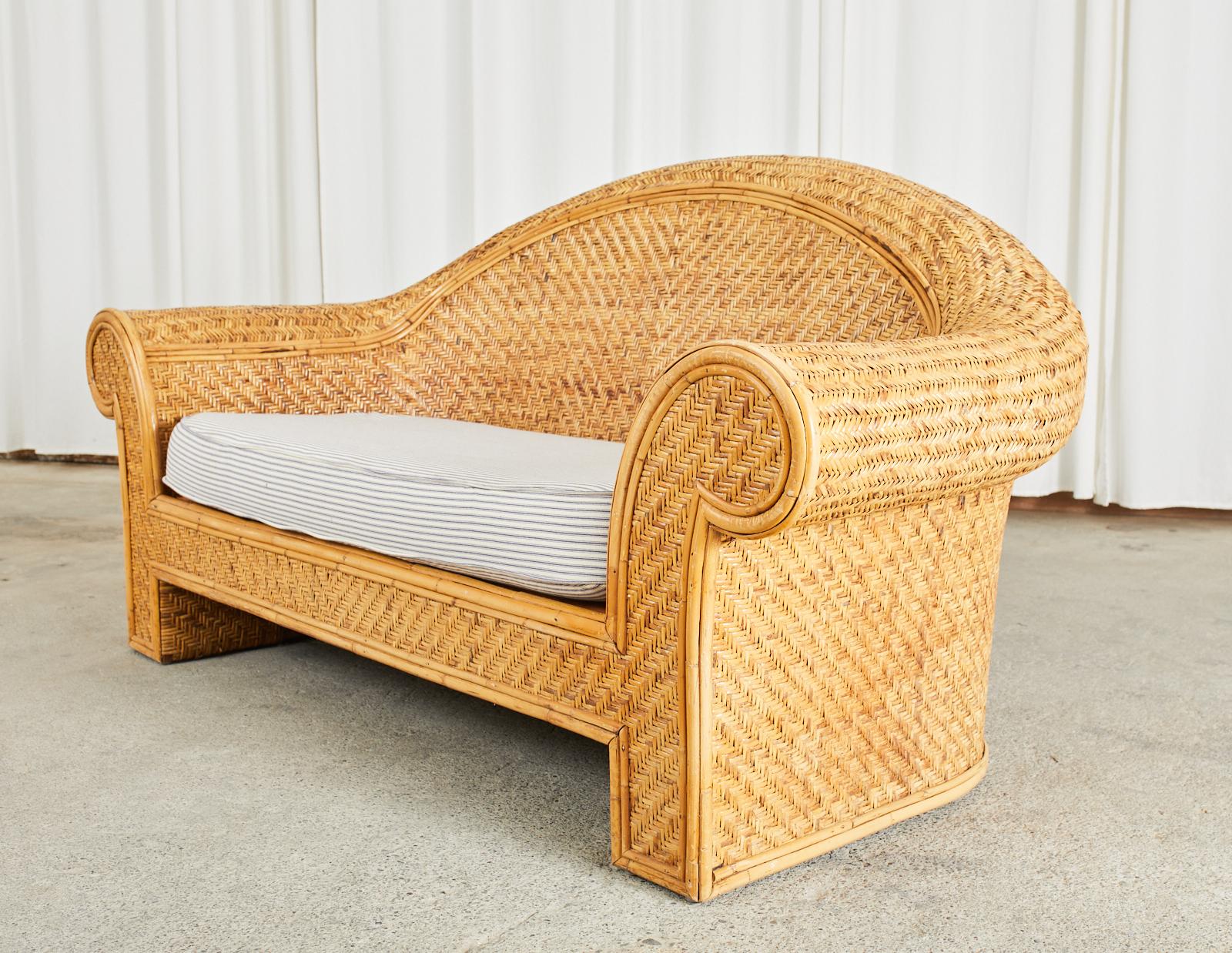 Gorgeous organic modern sofa settee featuring a wood rattan frame covered with woven rattan wicker in a stylish geometric herringbone pattern. Attributed to O-Asian for Ralph Lauren Home. The sofa has a classic humpback that gracefully curves down