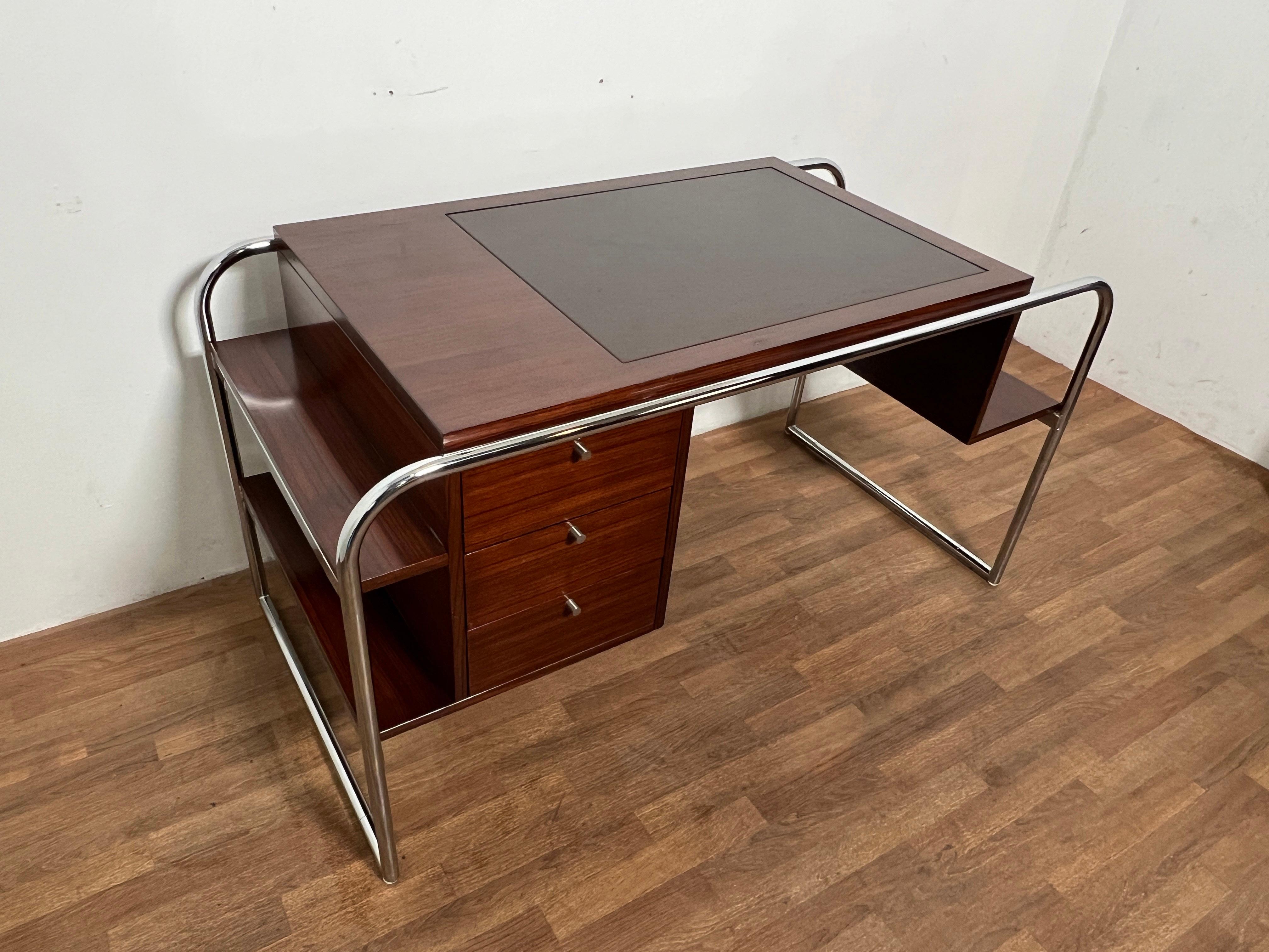 A Bauhaus inspired design in rosewood with tubular chrome framework and a leather insert top by Ralph Lauren from his Laurel Drive Collection.