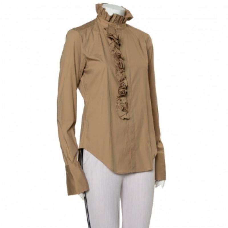 Ralph Lauren updates a simple beige cotton top with the help of ruffles and makes it a statement creation ideal to pair with smart pants and skirts. The women's top has long sleeves, front buttons, and ruffle trims on the front and on the raised