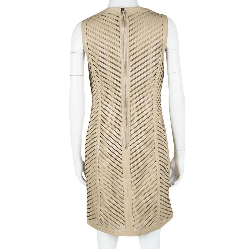 Look fierce and right on point with style in this Ralph Lauren dress! The dress is designed in a beige hue and covered with cut out detailing all over. A round neck and a back zipper complete this must-have piece.

Includes: The Luxury Closet