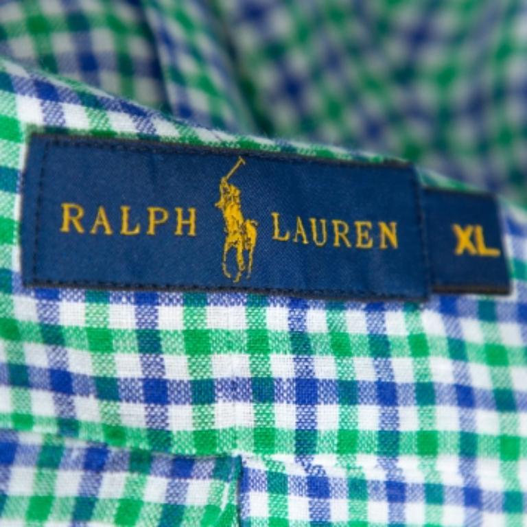 If you're wondering what to wear to work, this Ralph Lauren linen shirt is here to save the day. The shirt, styled with a collar, checkered print, and lined with front buttons, is comfortable and stylish. A pair of black trousers and oxfords will