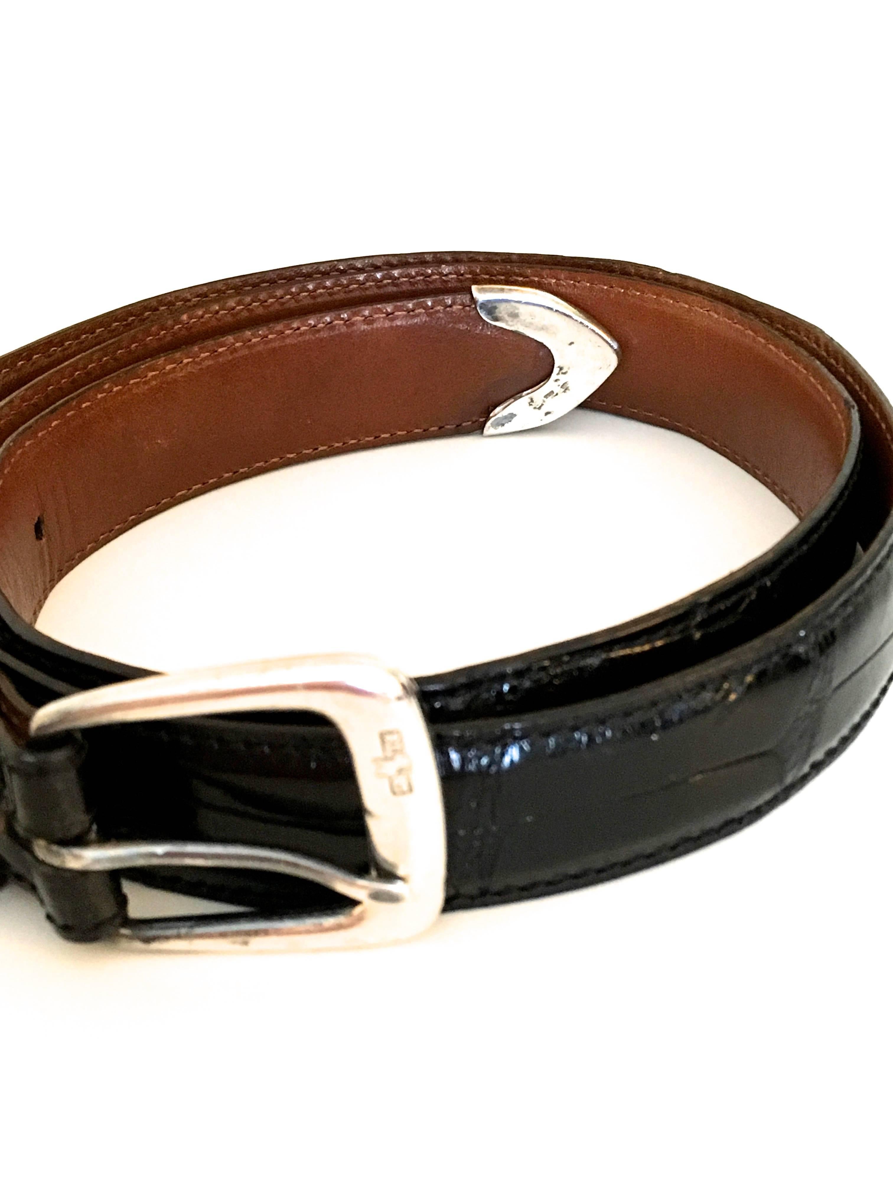 Presented here is a beautiful belt from Ralph Lauren. The belt is made from black alligator and has a gorgeously crafted sterling silver buckle. The tip of the belt is also crafted from sterling silver. The belt is 39 inches in total length and 1.0