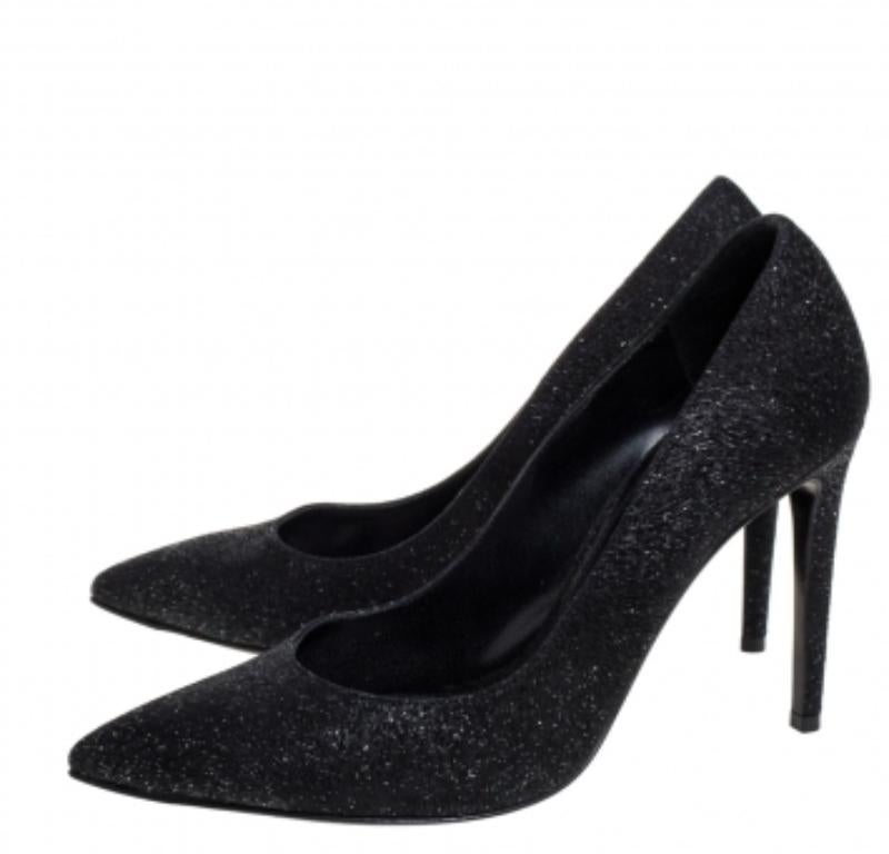 Add a subtle touch of glam to your look by donning these glitter pumps. This pair of Ralph Lauren pumps are more than just a basic fashion statement. They come with pointed toes and stiletto heels. This pair of gorgeous black pumps are complete with