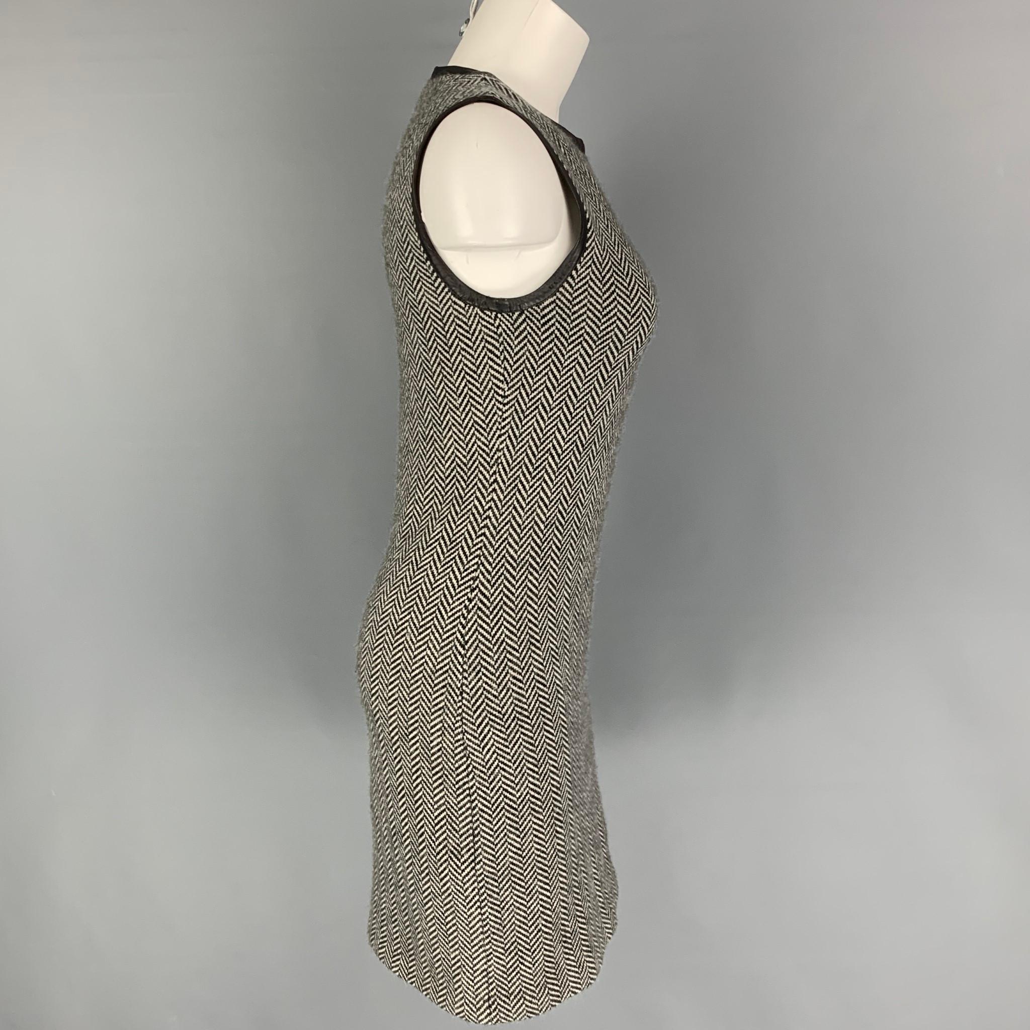 RALPH LAUREN 'Black Label' dress comes in a black & white herringbone cashmere featuring a leather trim, sleeveless, and a back zip up closure. 

Very Good Pre-Owned Condition.
Marked: M

Measurements:

Shoulder: 13.5 in.
Bust: 30 in.
Waist: 28