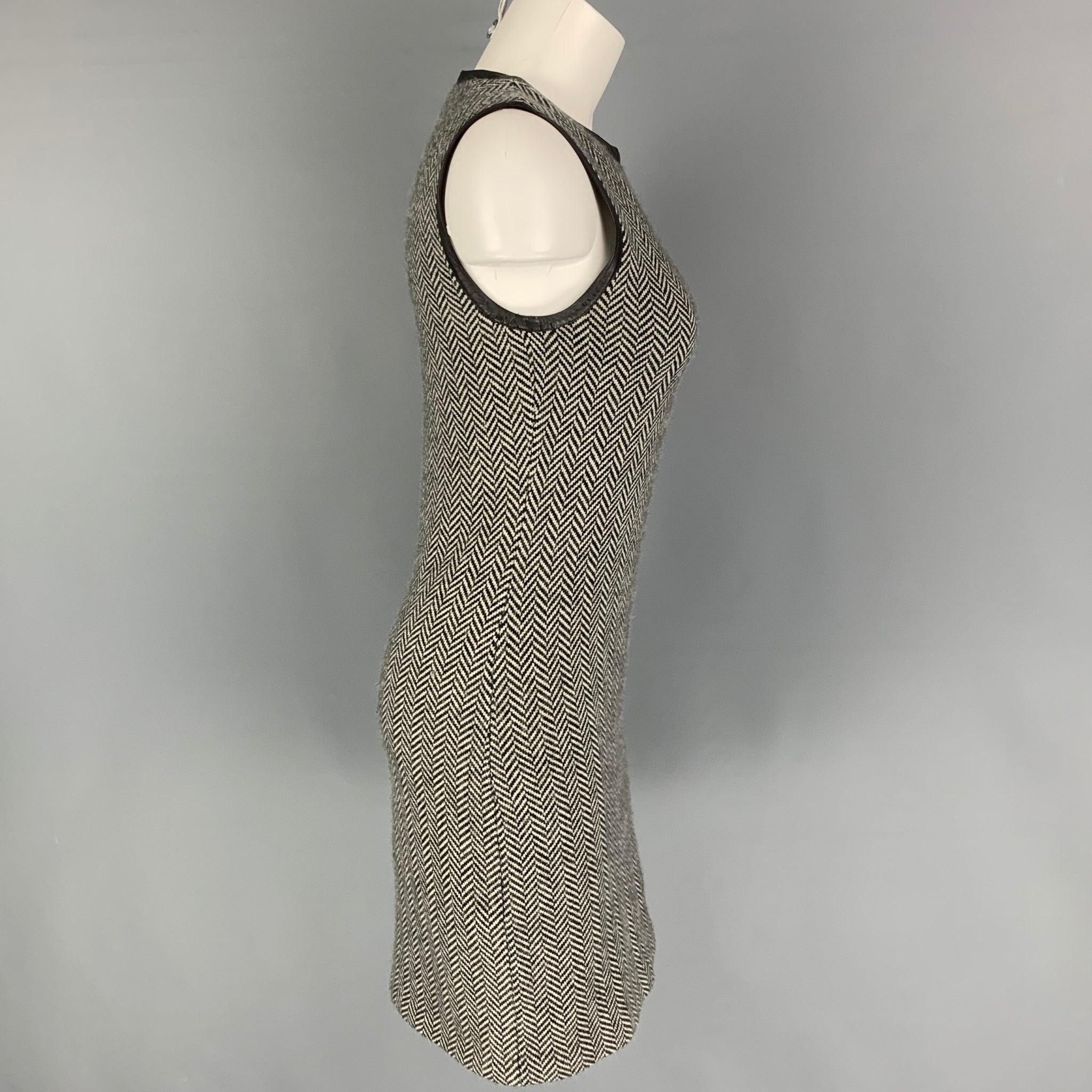 RALPH LAUREN 'Black Label' dress comes in a black & white herringbone cashmere featuring a leather trim, sleeveless, and a back zip up closure.
Very Good
Pre-Owned Condition. 

Marked:   M 

Measurements: 
 
Shoulder: 13.5 inches  Bust: 30 inches
