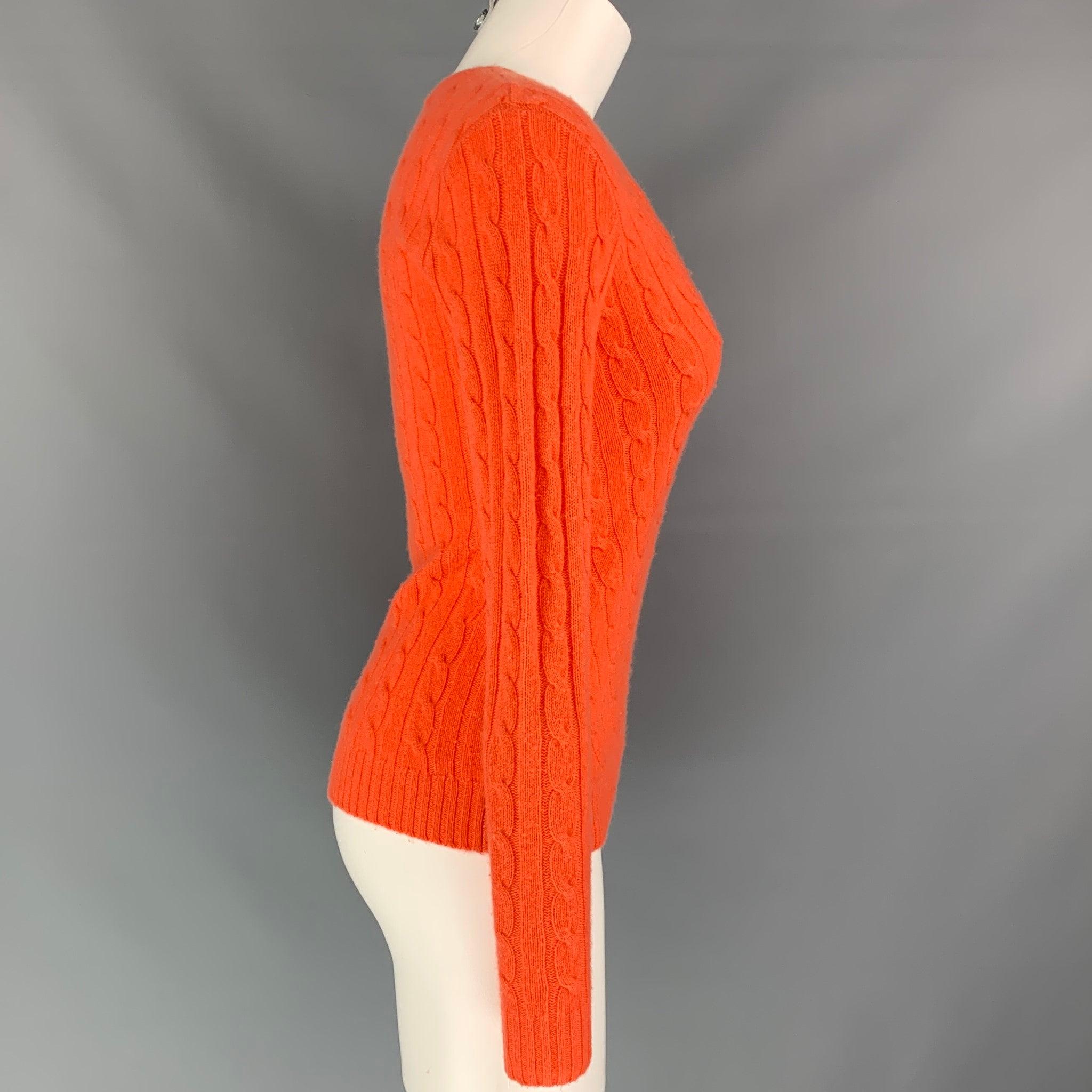 RALPH LAUREN Black Label sweater comes in a orange cable knit cashmere featuring a slim fit and a v-neck.
Very Good
Pre-Owned Condition. 

Marked:   S 

Measurements: 
 
Shoulder: 14.5 inches Bust: 36 inches  Sleeve: 26 inches  Length: 23 inches 

 