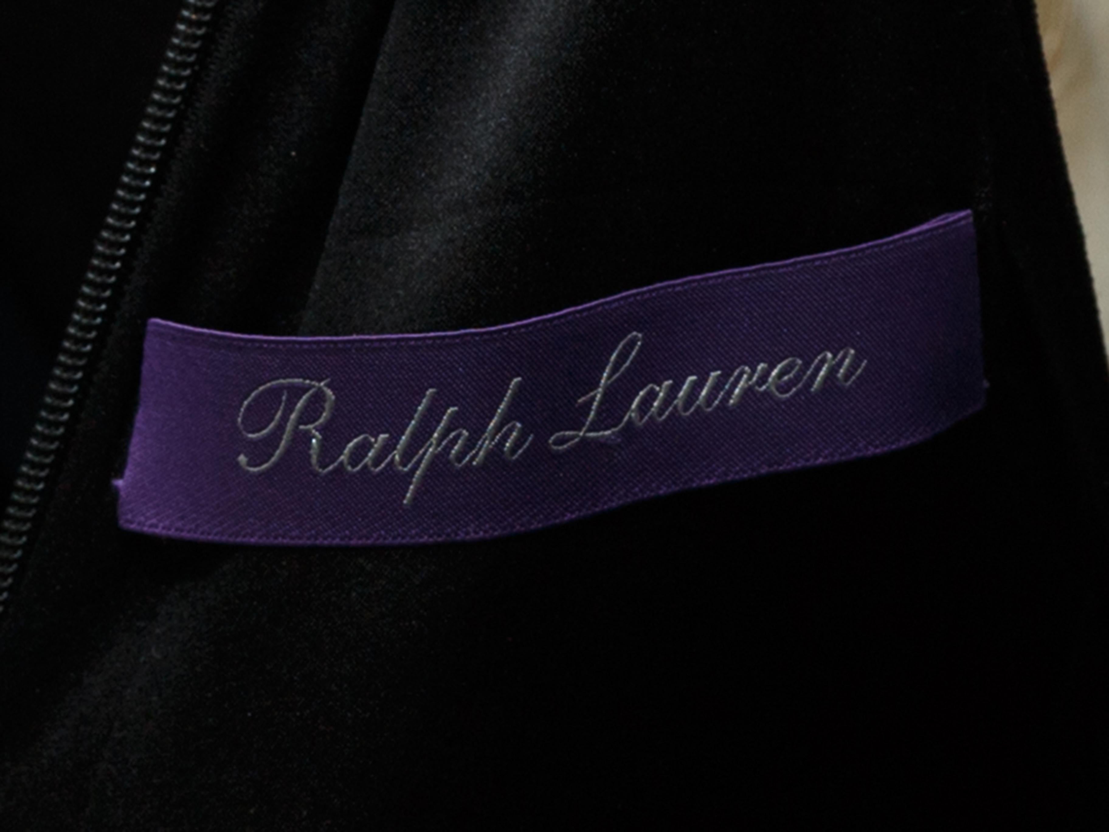 Product details: Black sleeveless halter dress by Ralph Lauren. Leather detailing at halter straps. Slit at front hem. Zip closure at back. 32