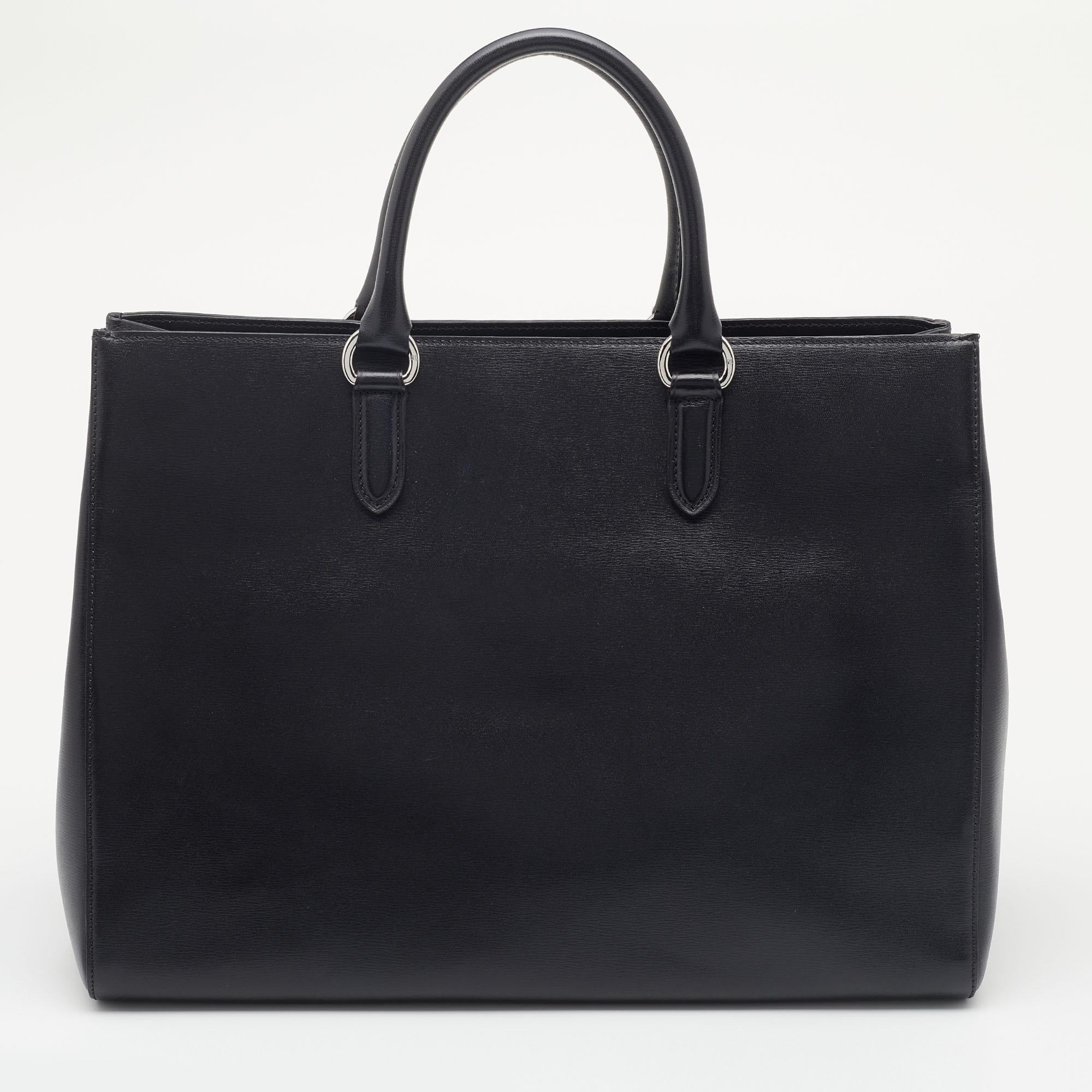 This tote from Ralph Lauren is attractive, sturdy, and practical for everyday use. It is crafted using black leather on the exterior. It showcases two handles, silver-toned hardware, and a fabric-lined interior. Own this superb Ralph Lauren creation