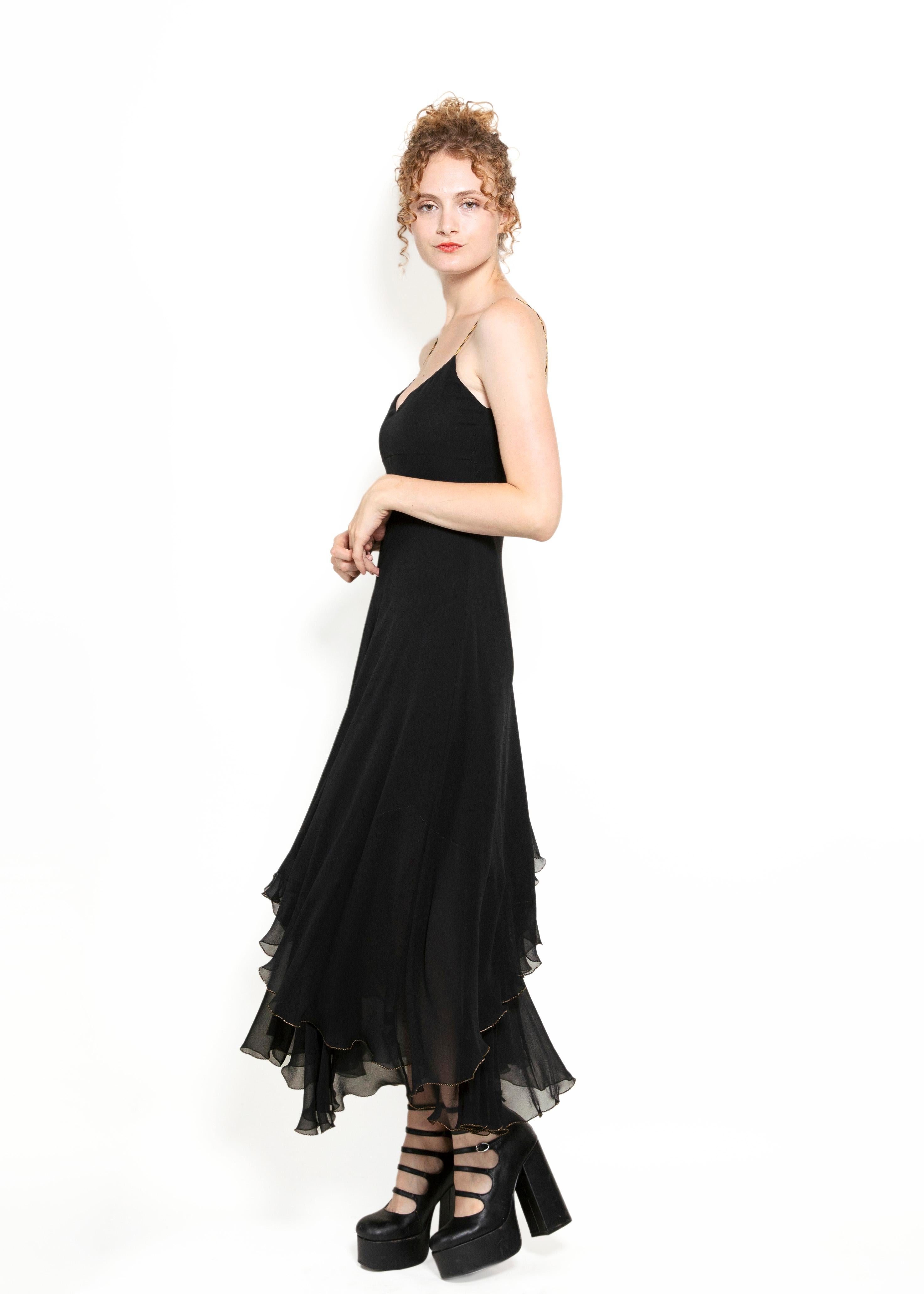 Take a daring plunge into opulence with this Ralph Lauren Black Silk Chiffon, featuring luxe gold and black braided straps for a touch of grandeur. Embrace courage and style with the bold and beautiful ruffle and layer design. Show off your daring